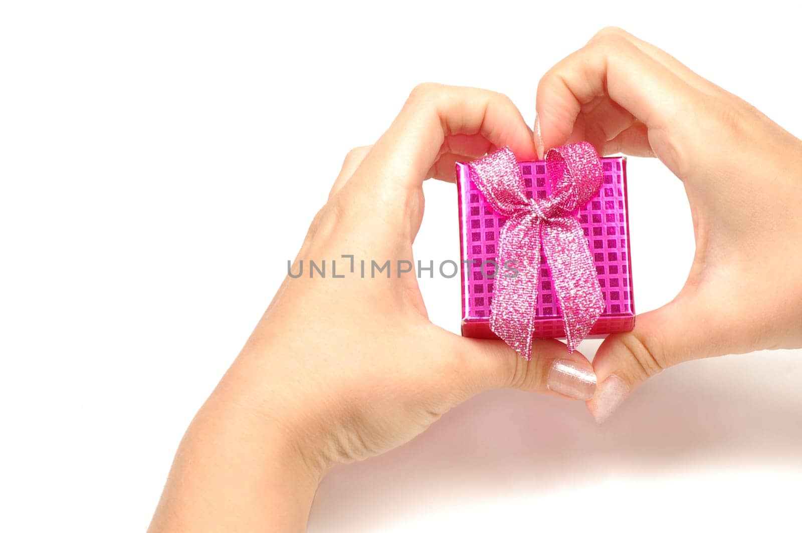The little pink gift box is in heart shape from hands.