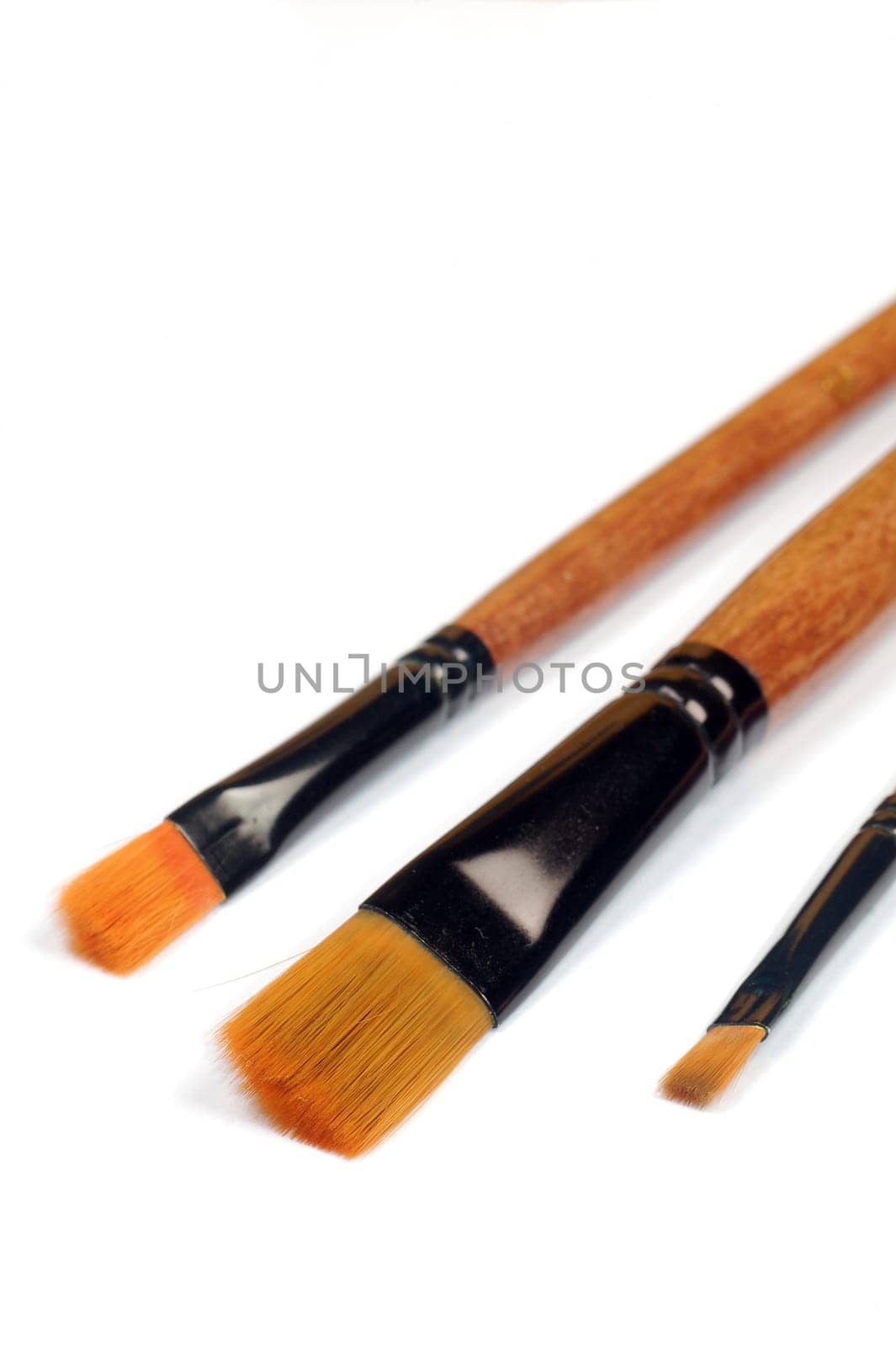 Three paint brushes are on the white background.