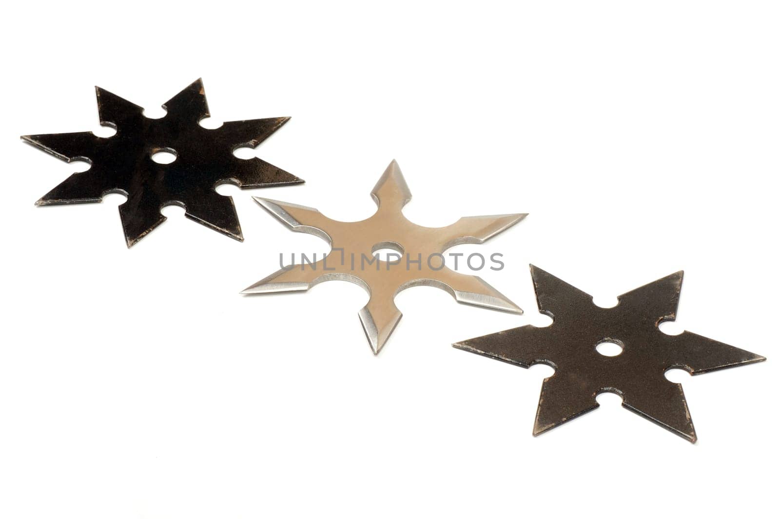 Three star shape shurikens are on white background.
