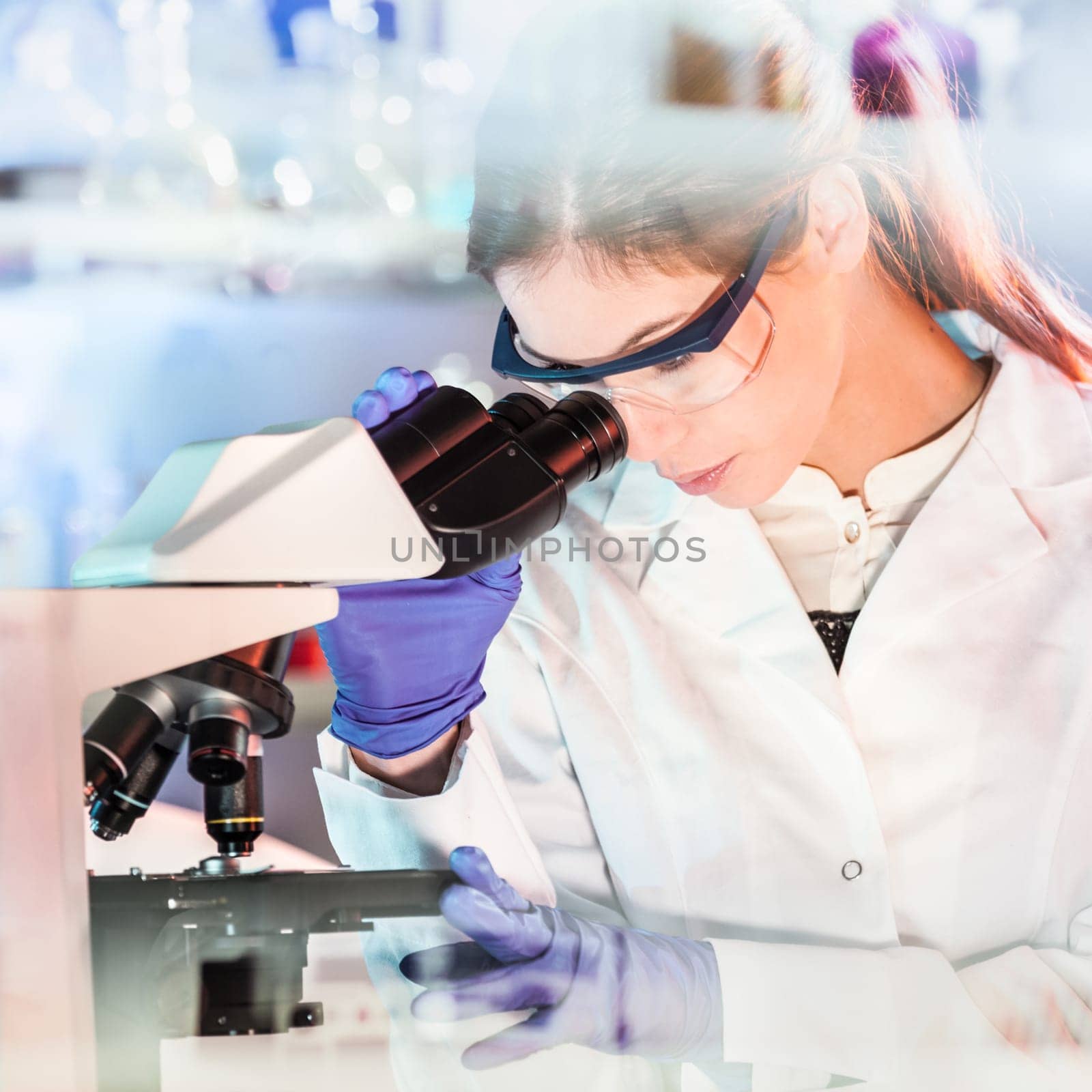 Life science female researcher microscoping in scientific genetic laboratory. Healthcare and biotechnology.