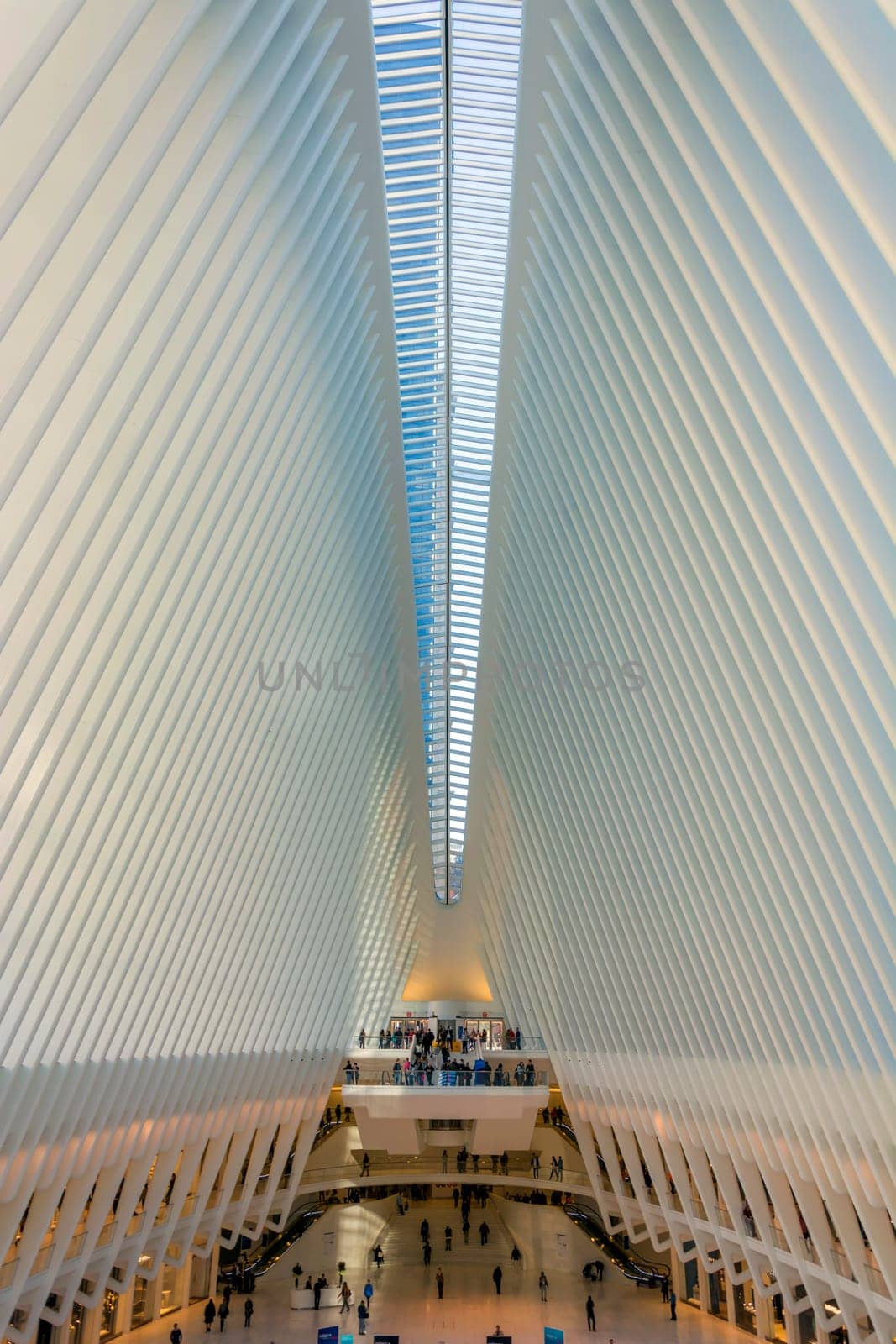 New York, USA, november 2016: People stand on a balcony looking at the stunning interior of Santiago Calatrava's Oculus, Fulton Street Station, in lower Manhattan.