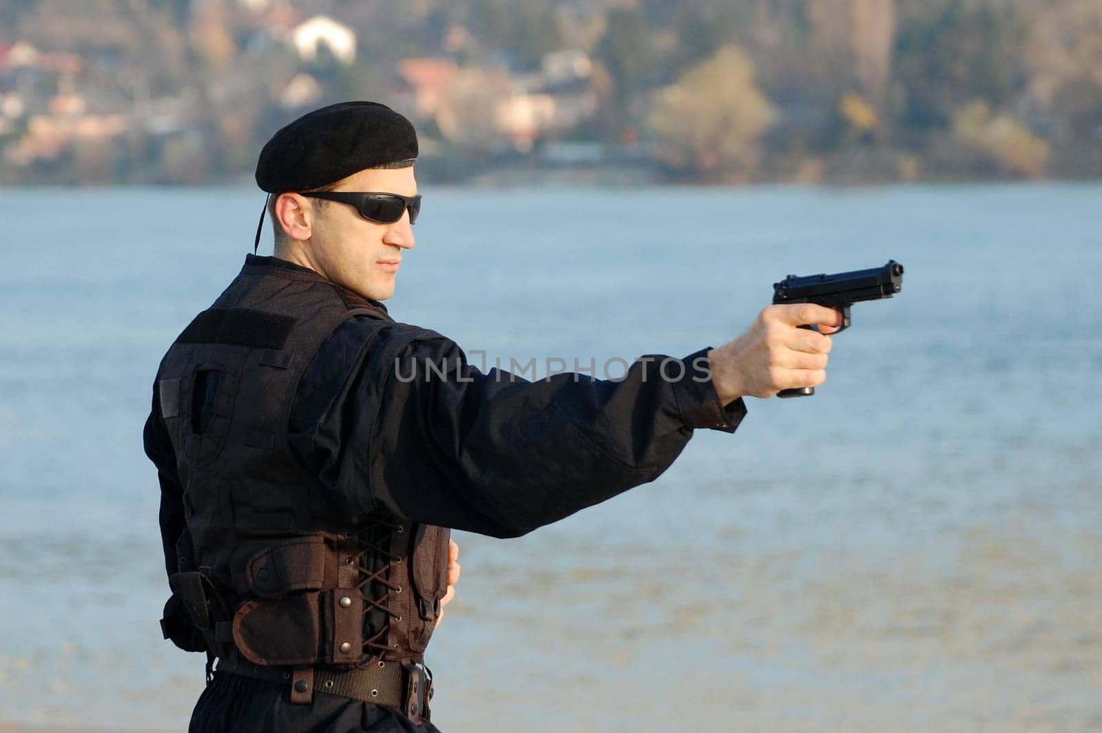 The security man is shooting with gun.