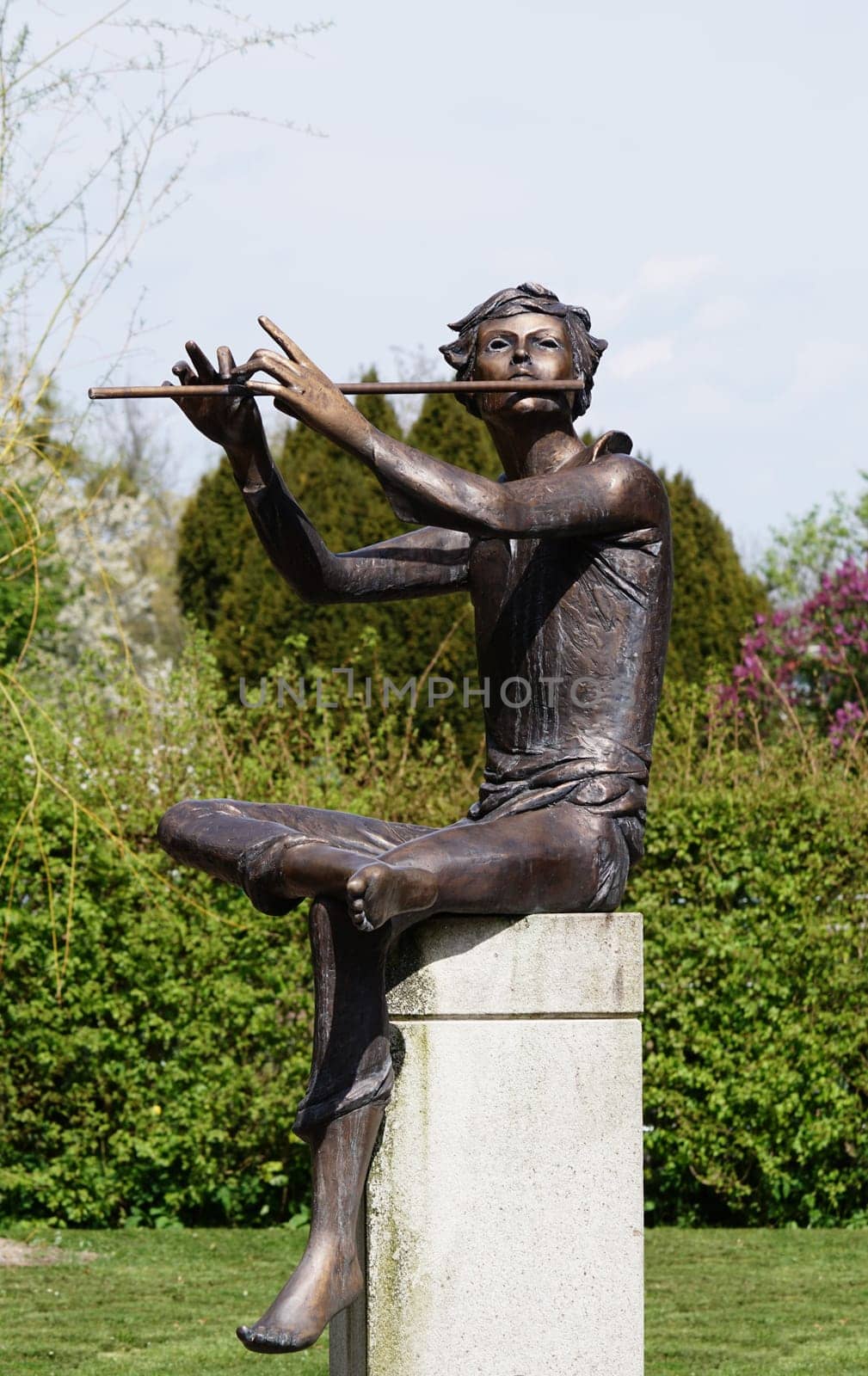 Sculpture of a flute player in the garden