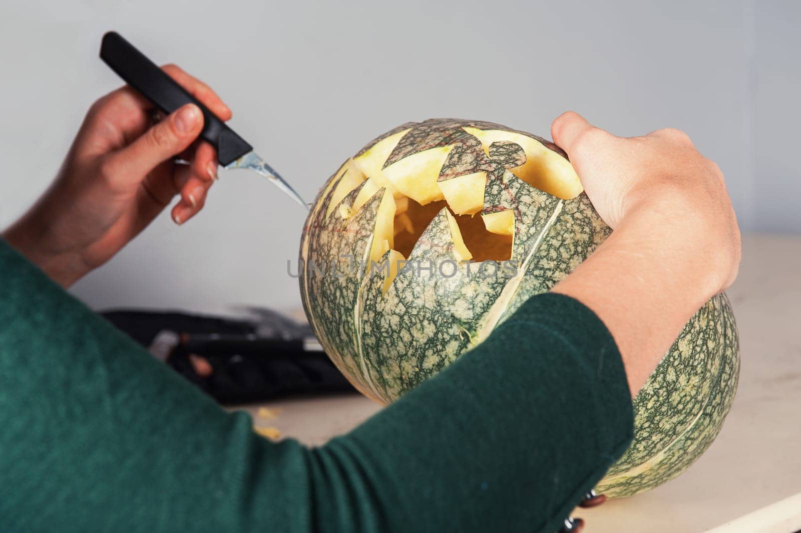 woman hands making pumpkin for halloween holidays.