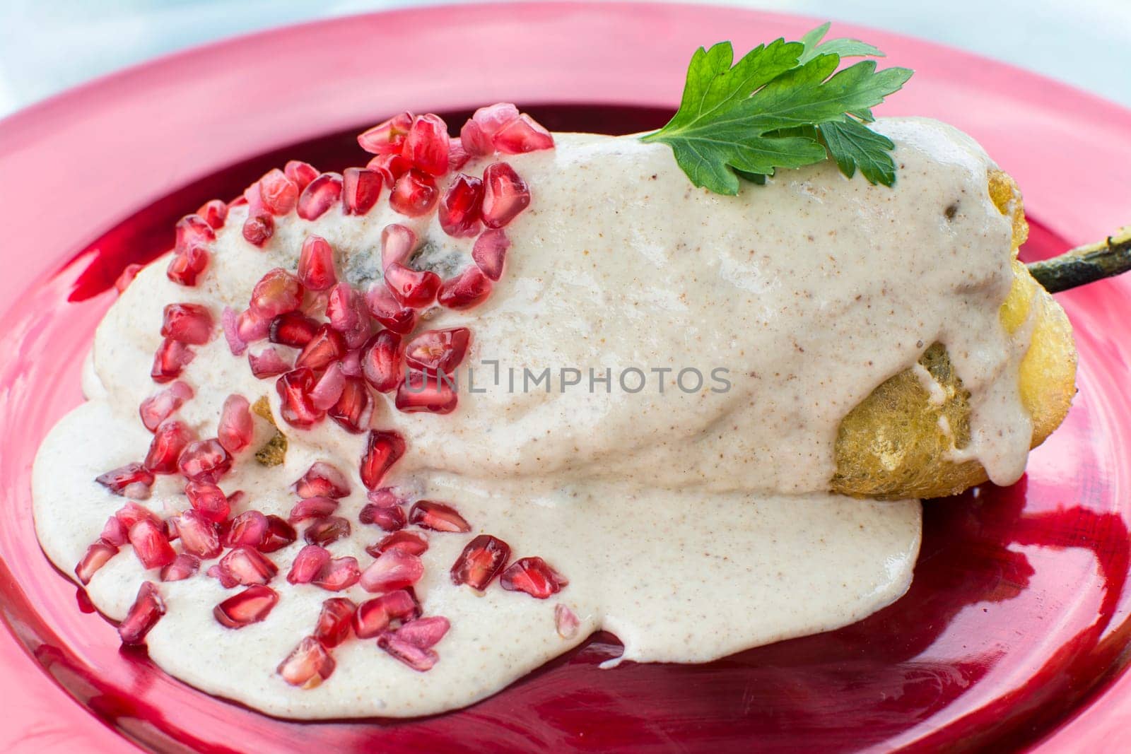 Chiles en nogada is a dish, served at room temperature with cold cream sauce, from Mexican cuisine.