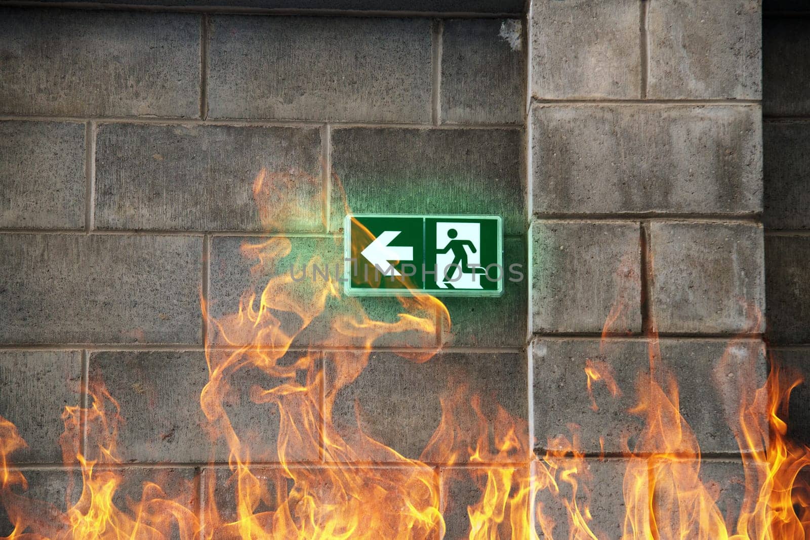 emergency fire exit on the stone wall with fire flames