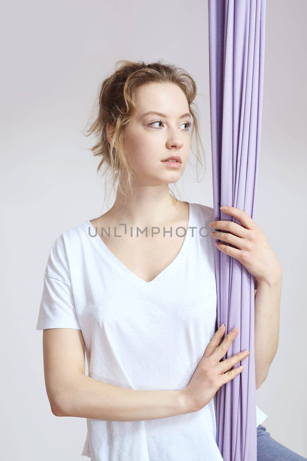 a woman is practicing yoga on a hose,aerial yoga