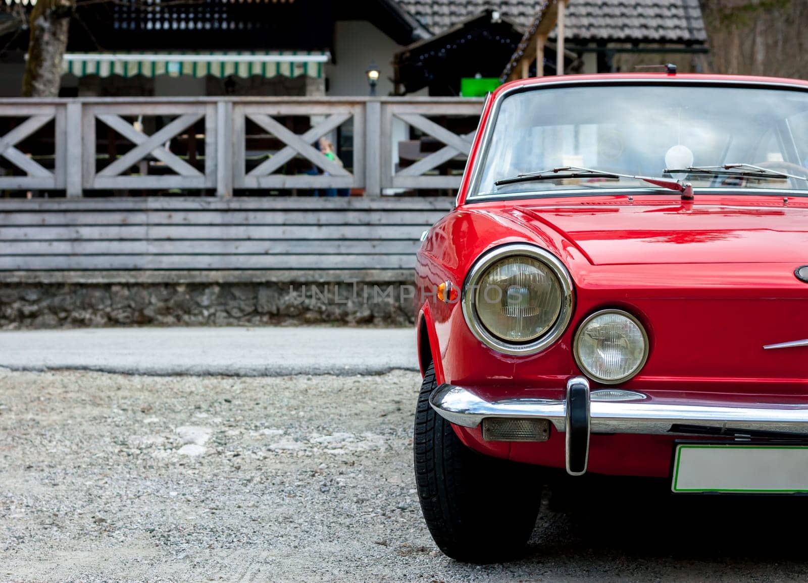 beautiful red retro sport car in the spring countryside