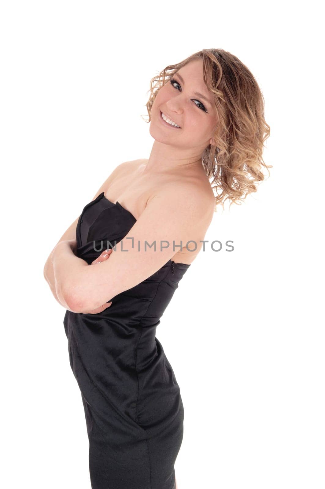 A young slim beautiful blond woman standing in profile, smiling, isolated.for white background..