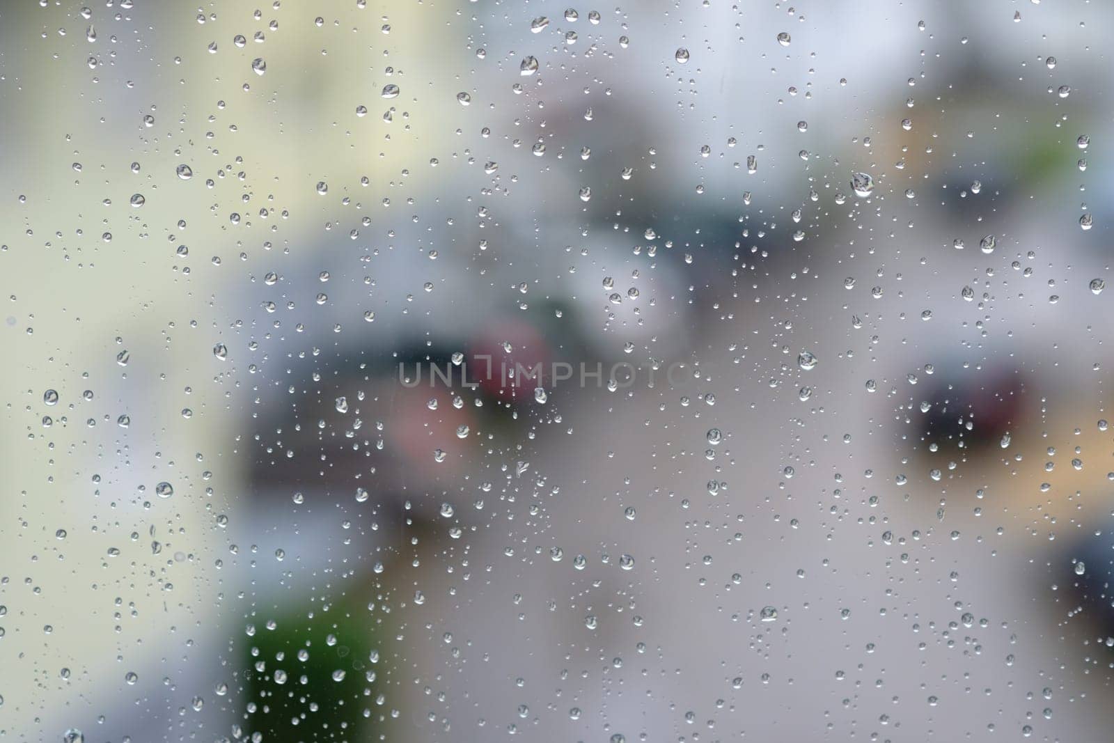 Raindrops on a window with a blurred background