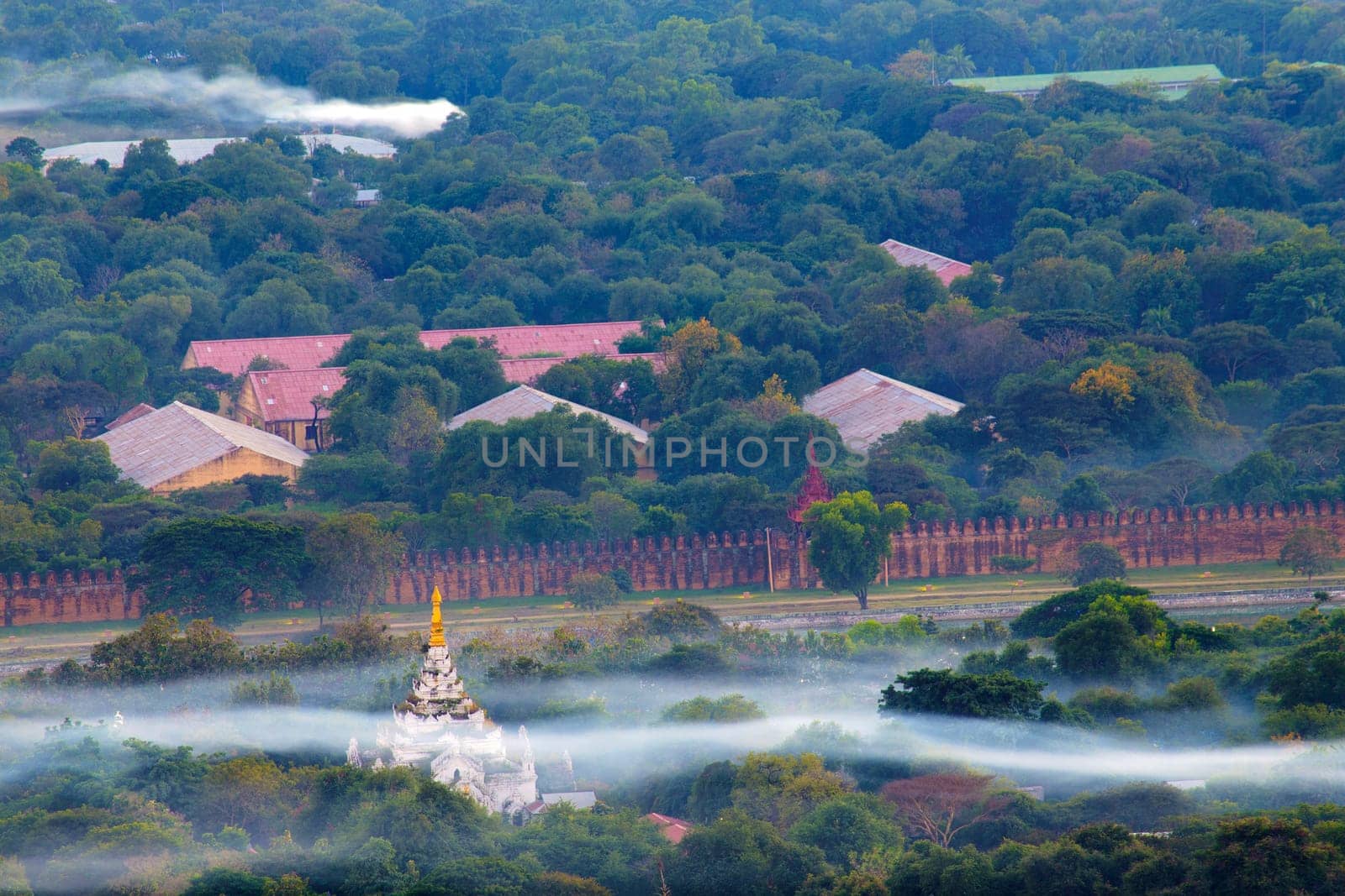 Mandalay with lake mountains, temples and pagodas seen from mandalay hill at sunset, Burma.