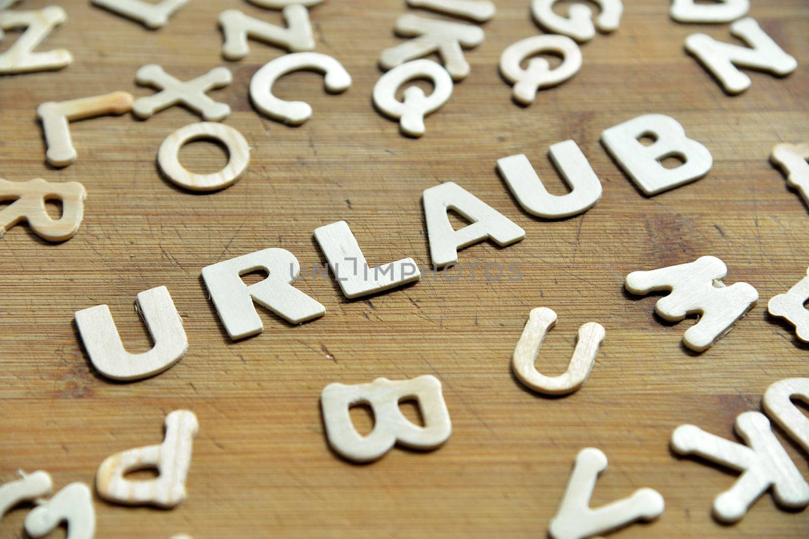 Holiday letters on wooden background