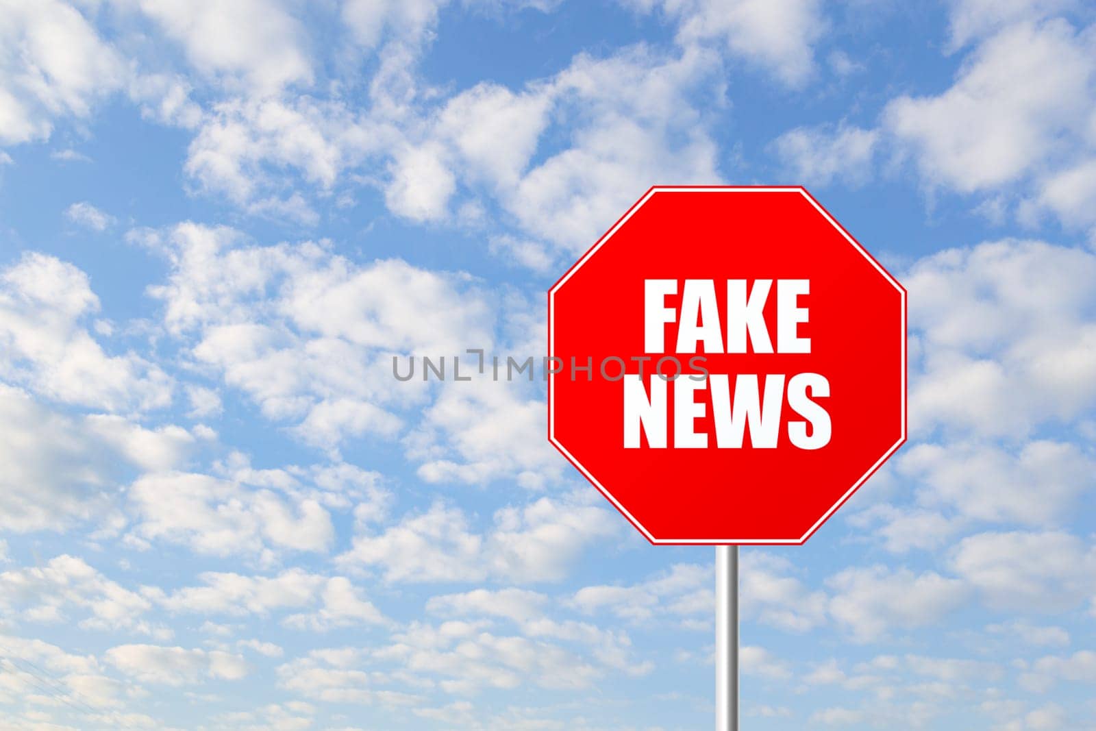 Stop fake news road sign against blue sky