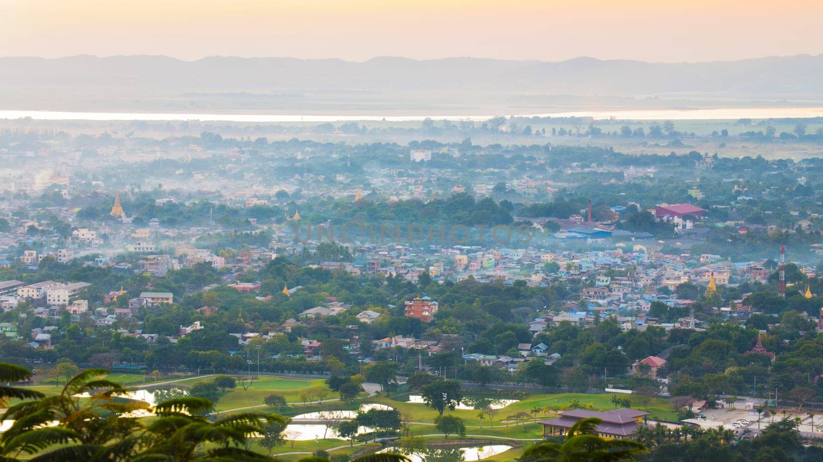 Mandalay with lake mountains, temples and pagodas seen from mandalay hill at sunset, Burma.