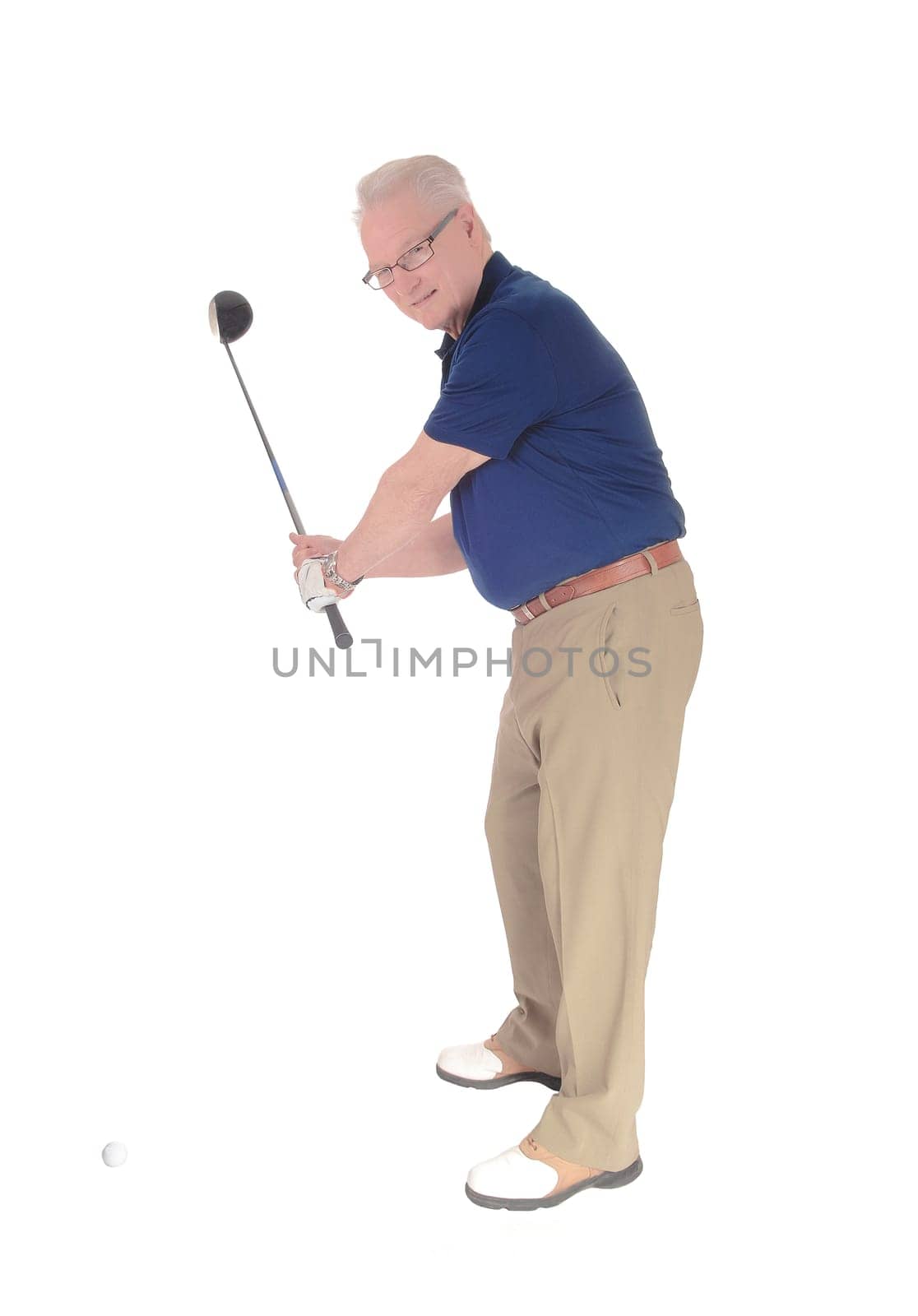 A handsome older senior practicing golf at his home standing isolated.for white background..