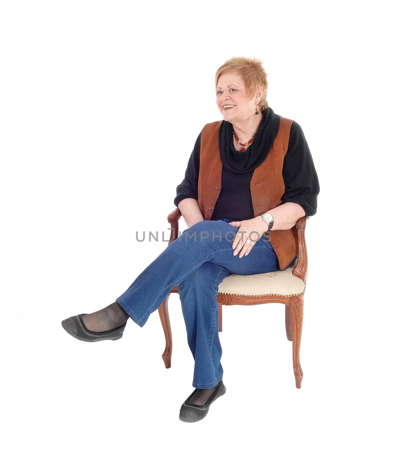 A lovely senior citizen woman in a brown vest sitting in an old armchair.relaxing, isolated for white background..