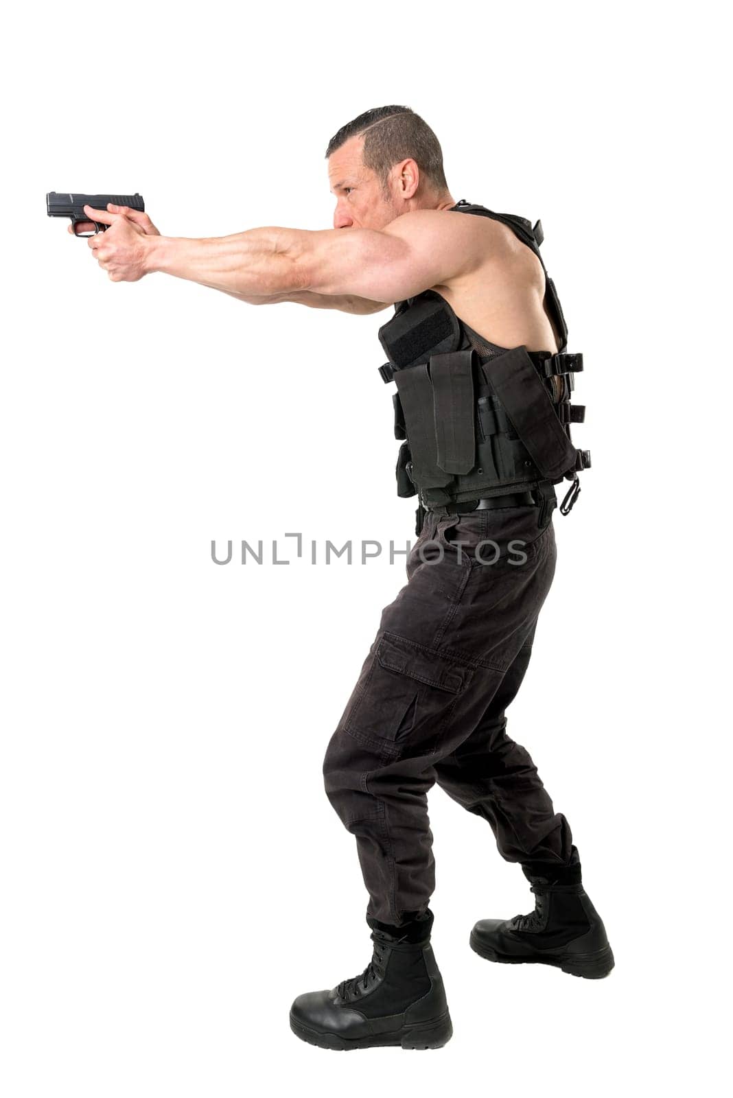 Man with tactical vest and gun isolated in white