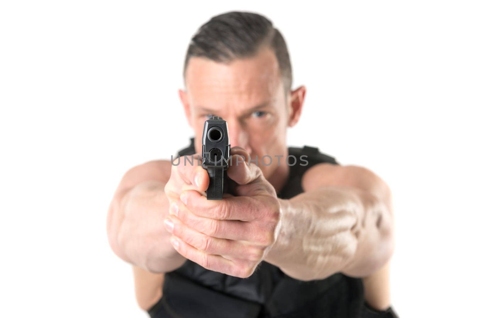 Man with tactical vest and gun isolated in white