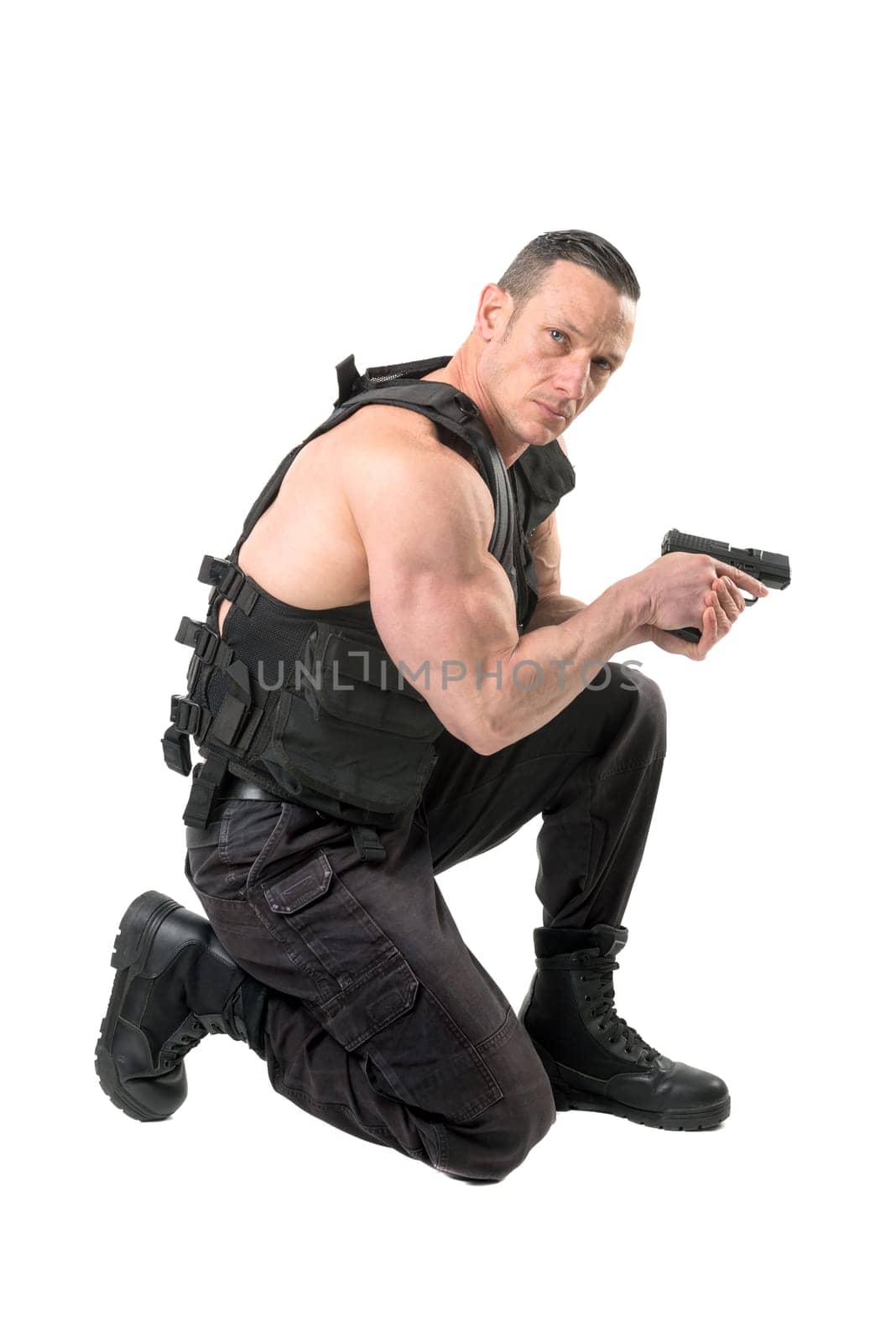Man with tactical vest and gun isolated in white