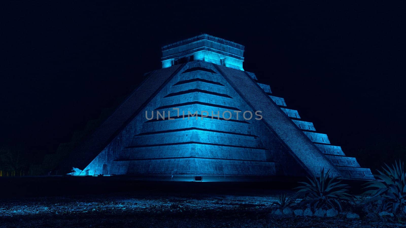 Pyramid of Chichen Itza at night with blue light in Mexico