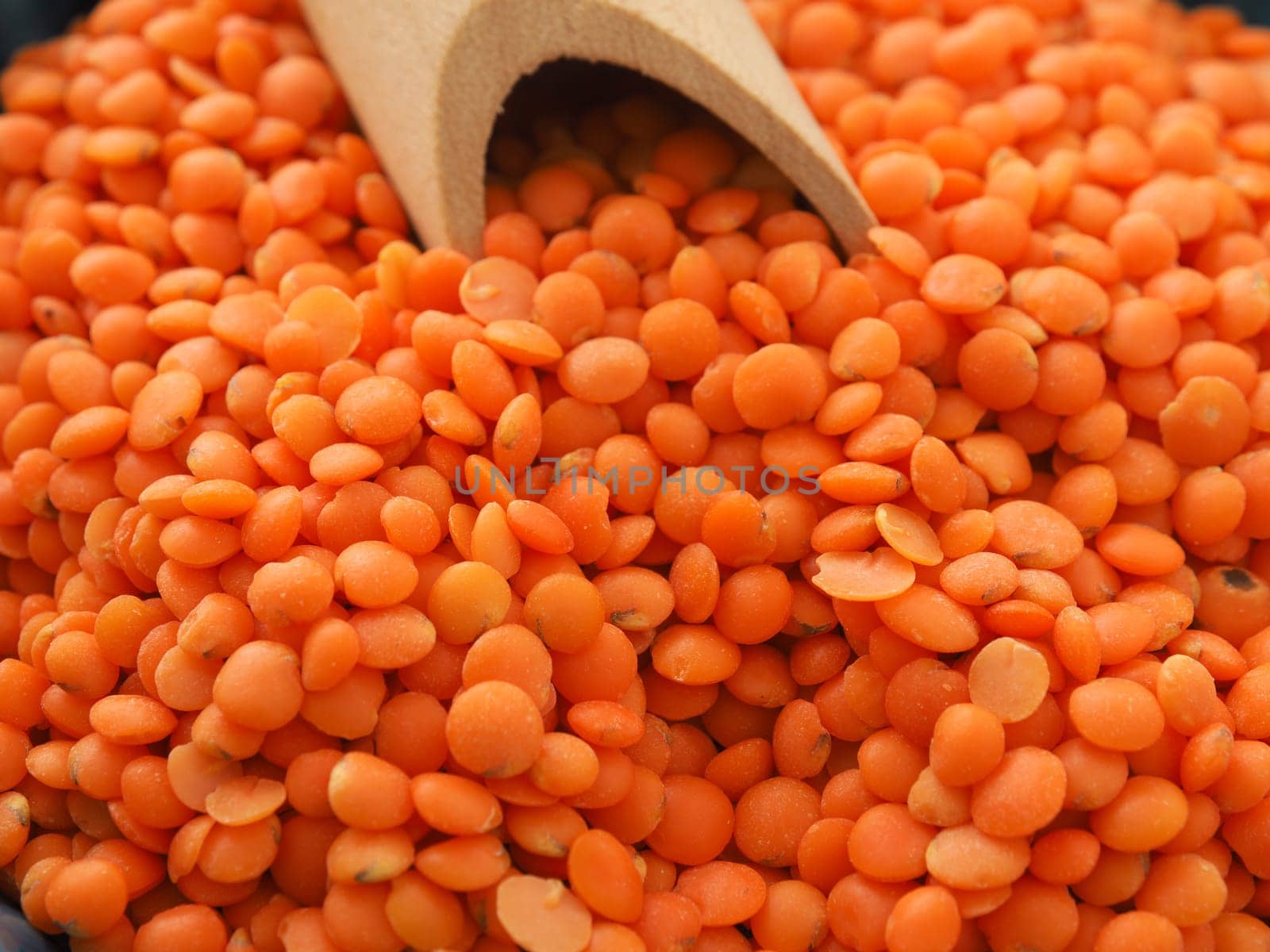 Organic red lentils on a wooden table