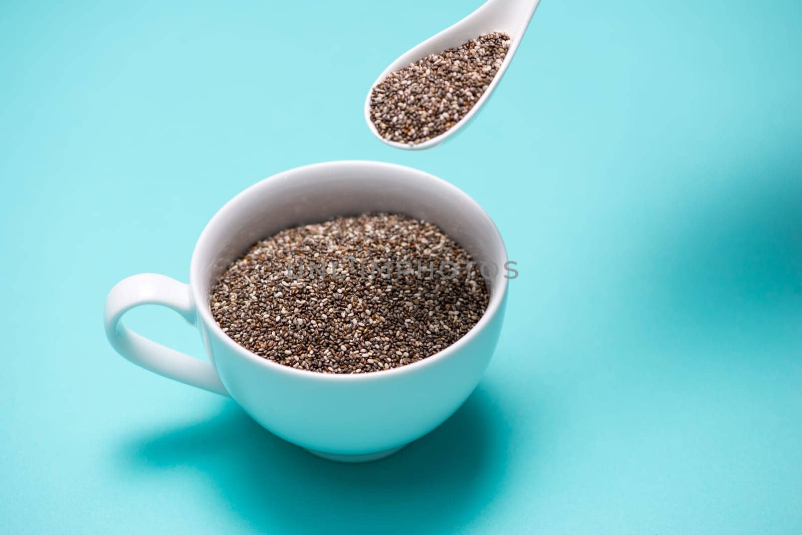Close-up of ealthy chia seeds in a spoon. Text space.