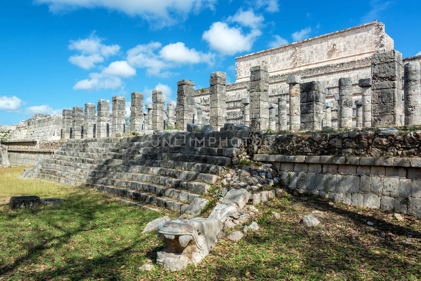 Snake head in front of the Thousand Columns in the ruins of Chichen Itza, Mexico