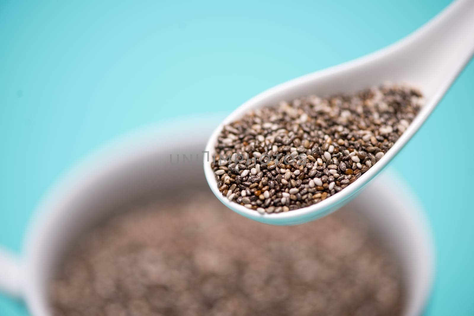Close-up of ealthy chia seeds in a spoon. Text space.
