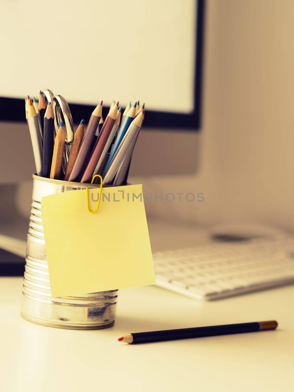 Sticky note close up on an office work space, selective focus retro film style