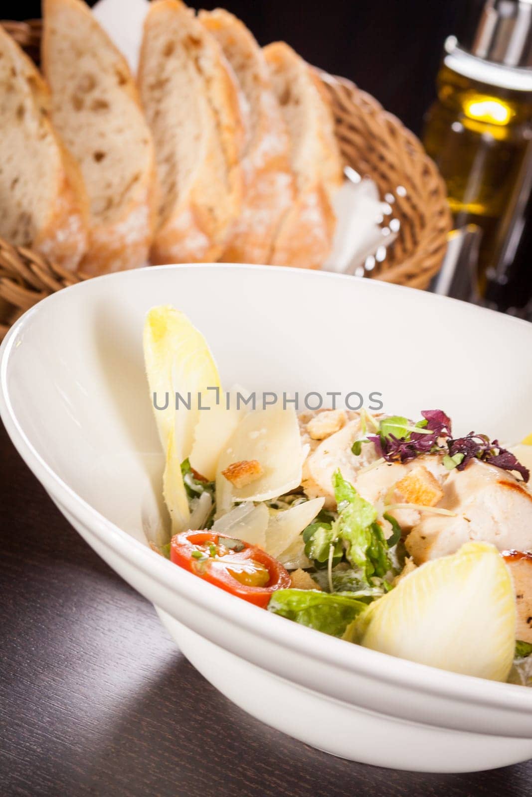 Fresh delicious caesarsalat with grilled chicken bust parmesan splinters and croutons