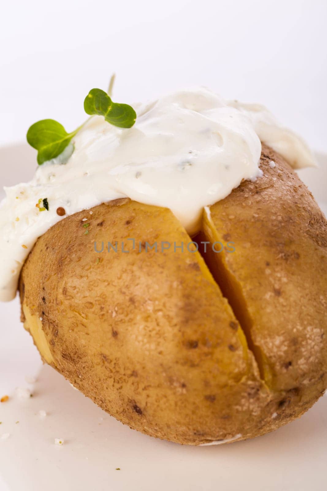 fresh foilpotato from the oven with herb quark sour cream and fresh herbs