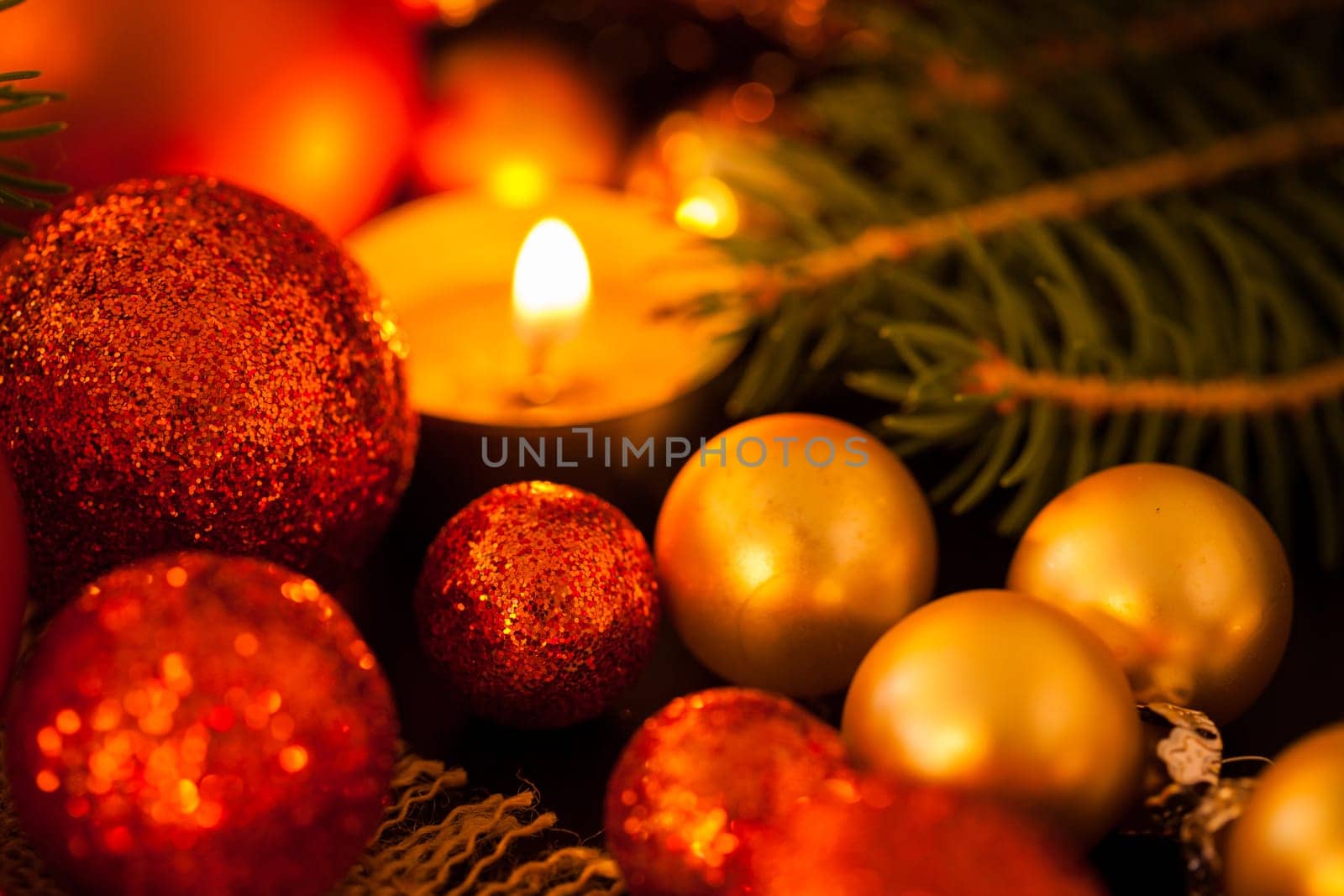 Warm golden and orange Christmas decoration with candlelight as close-up in context