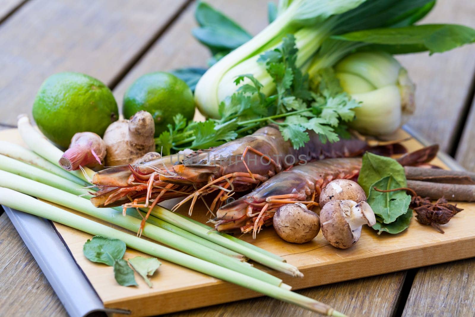 Ingredients for Tom Yam soup with lemongrass shrimp coriander on a kitchen board