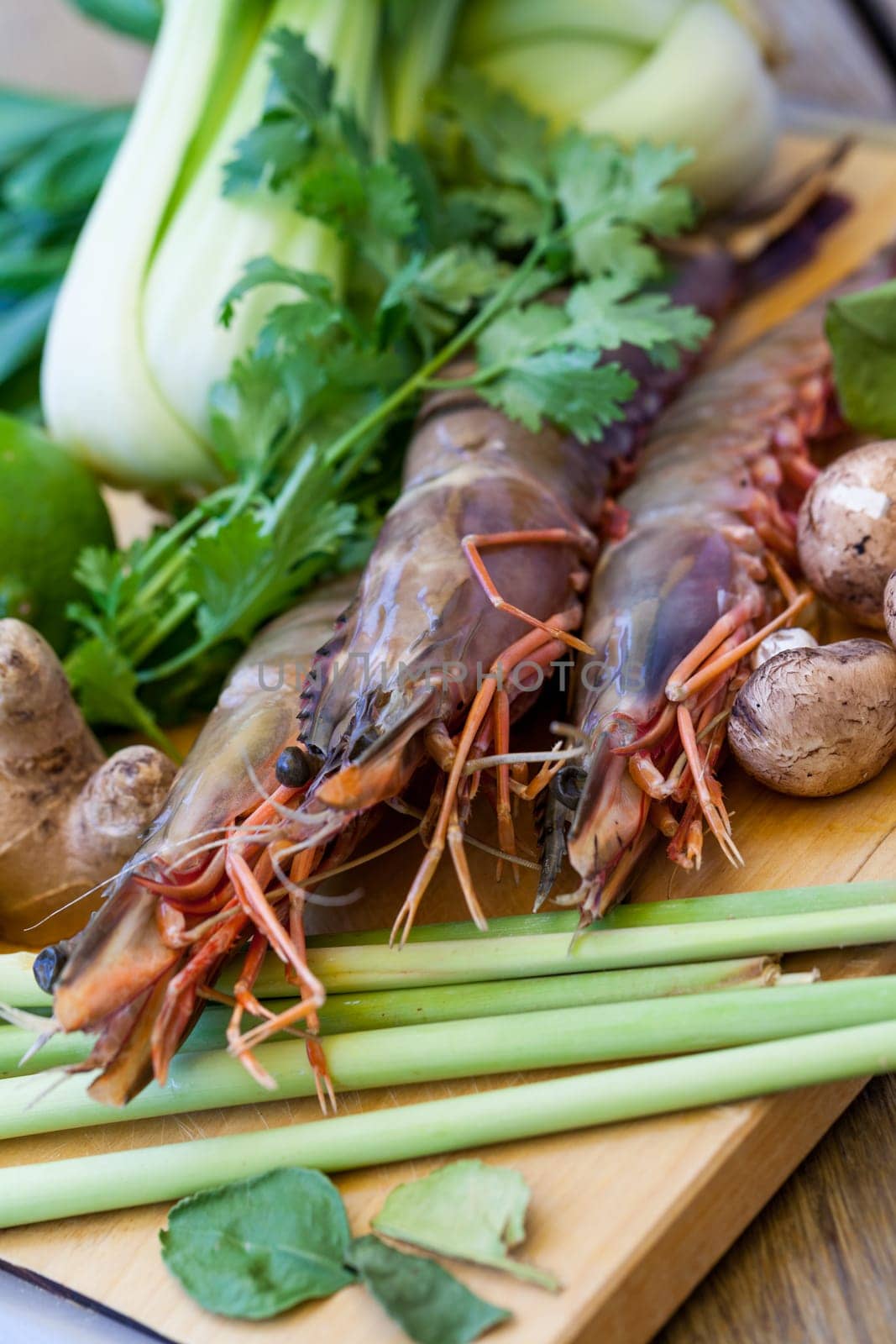 Ingredients for Tom Yam soup with lemongrass shrimp coriander on a kitchen board