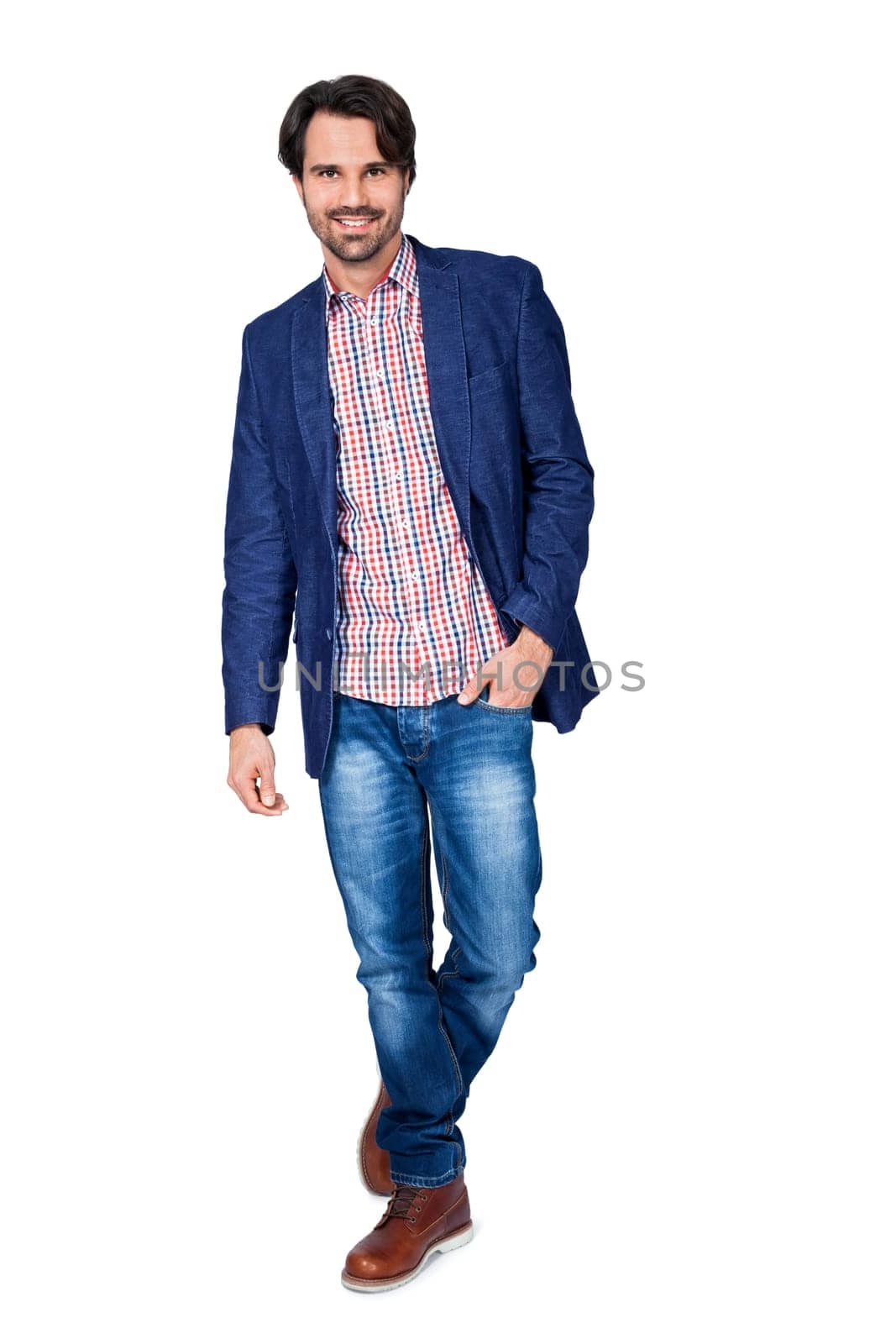 Young man in trendy casual look with dark hair and beard isolated against a white background