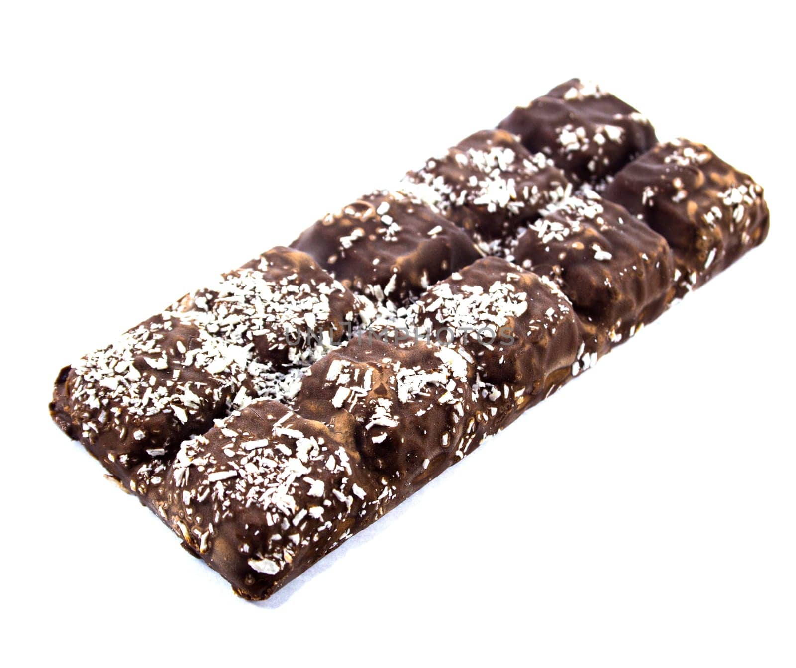Closeup of chocolate bar with coconuts isolated on white.