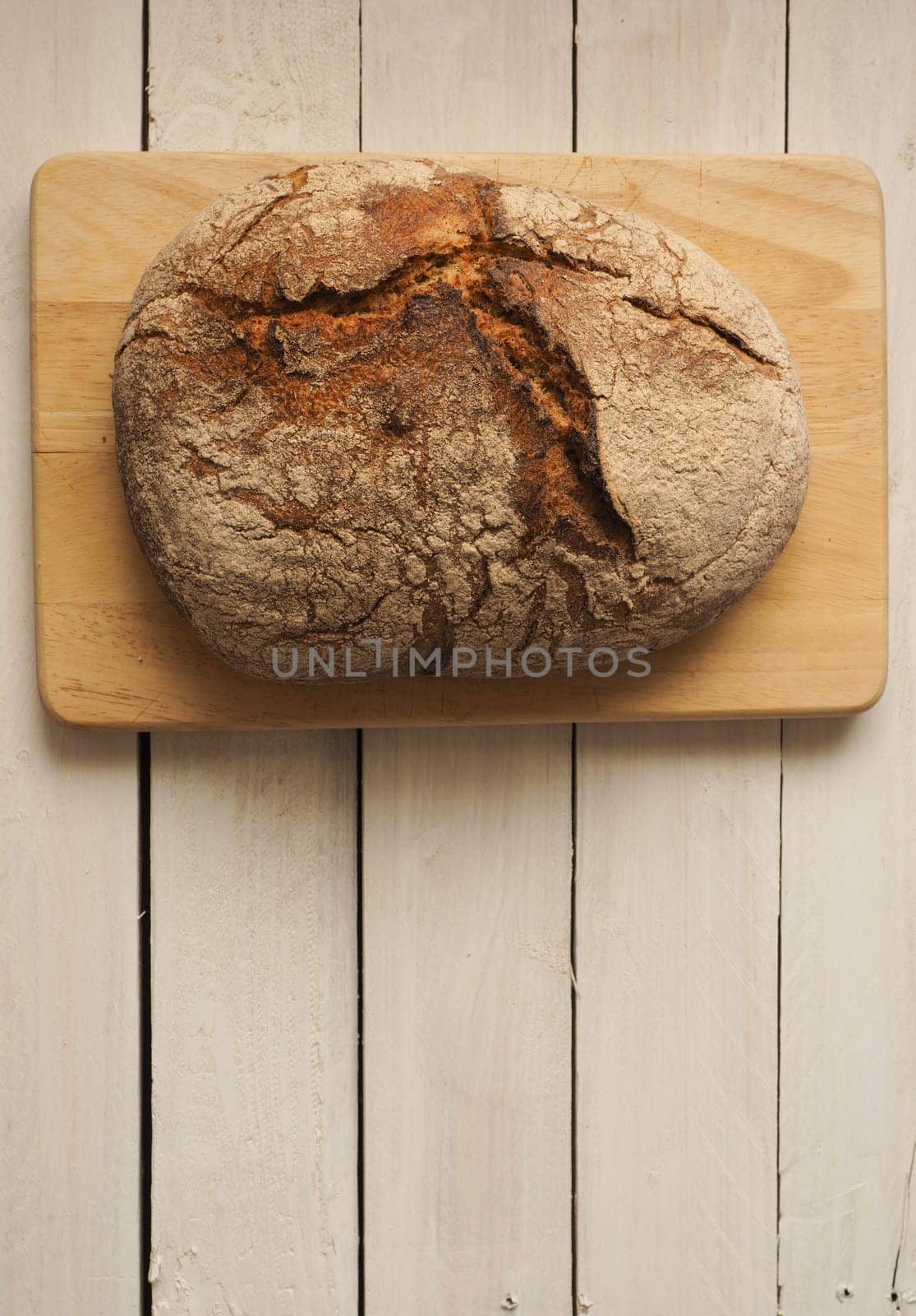Tasty bread on a rustic wooden background with space for text, view from above