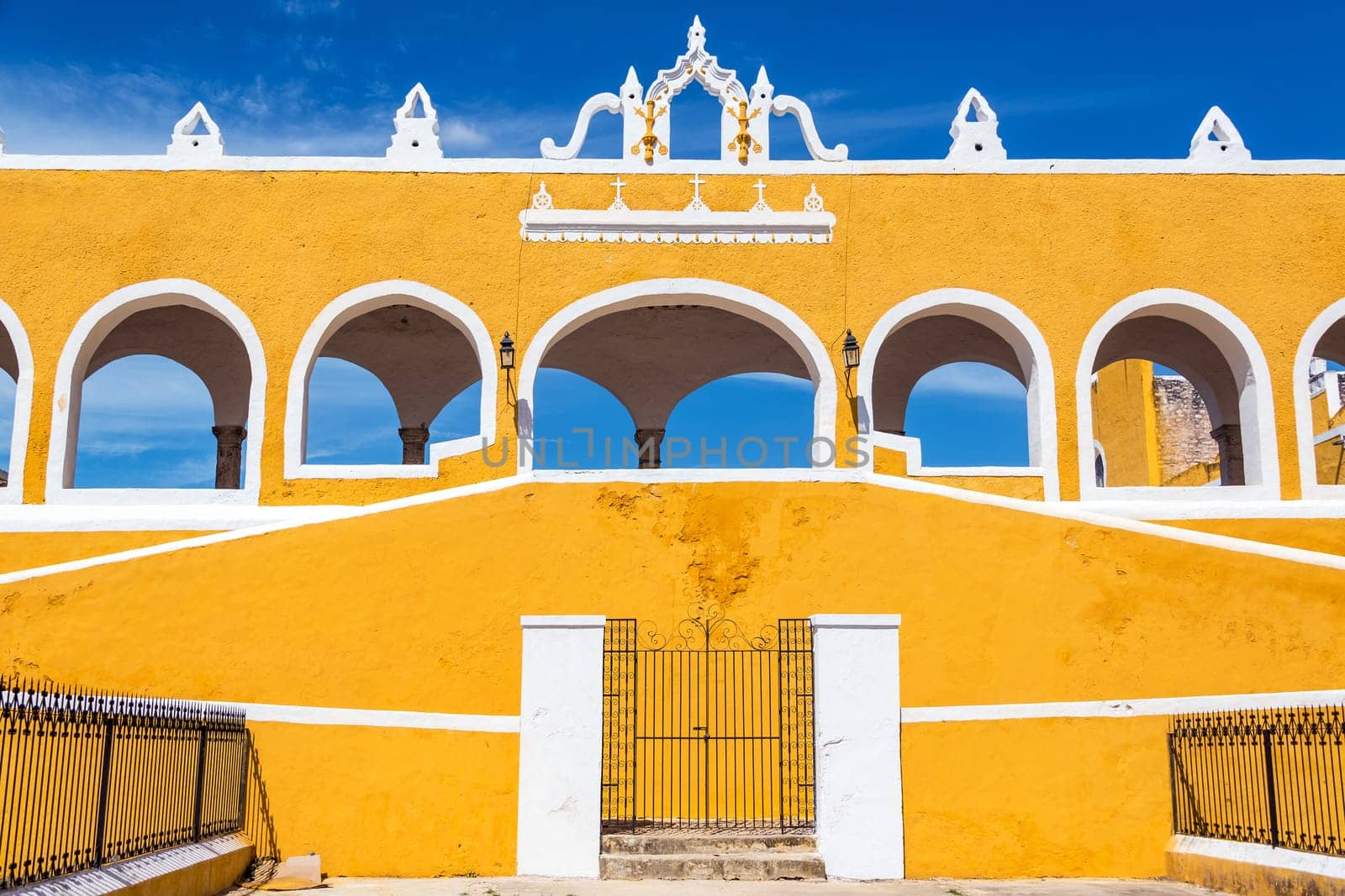 Exterior of the beautiful yellow monastery in Izamal, Mexico with a stunning blue sky