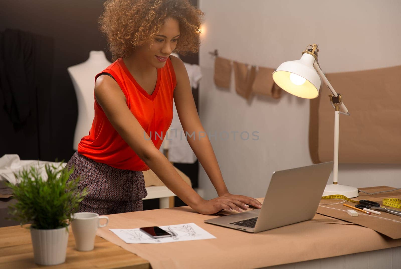 A young fashion designer working on her atelier