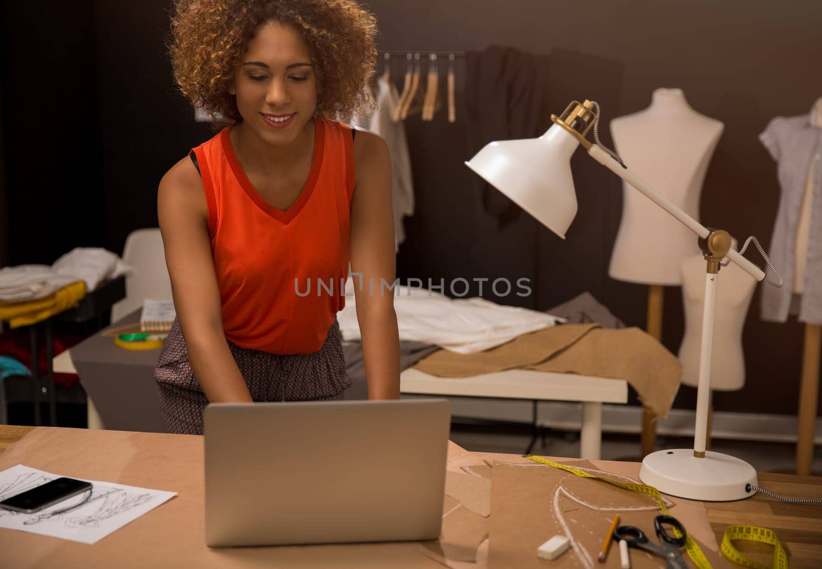 A young fashion designer working on her atelier