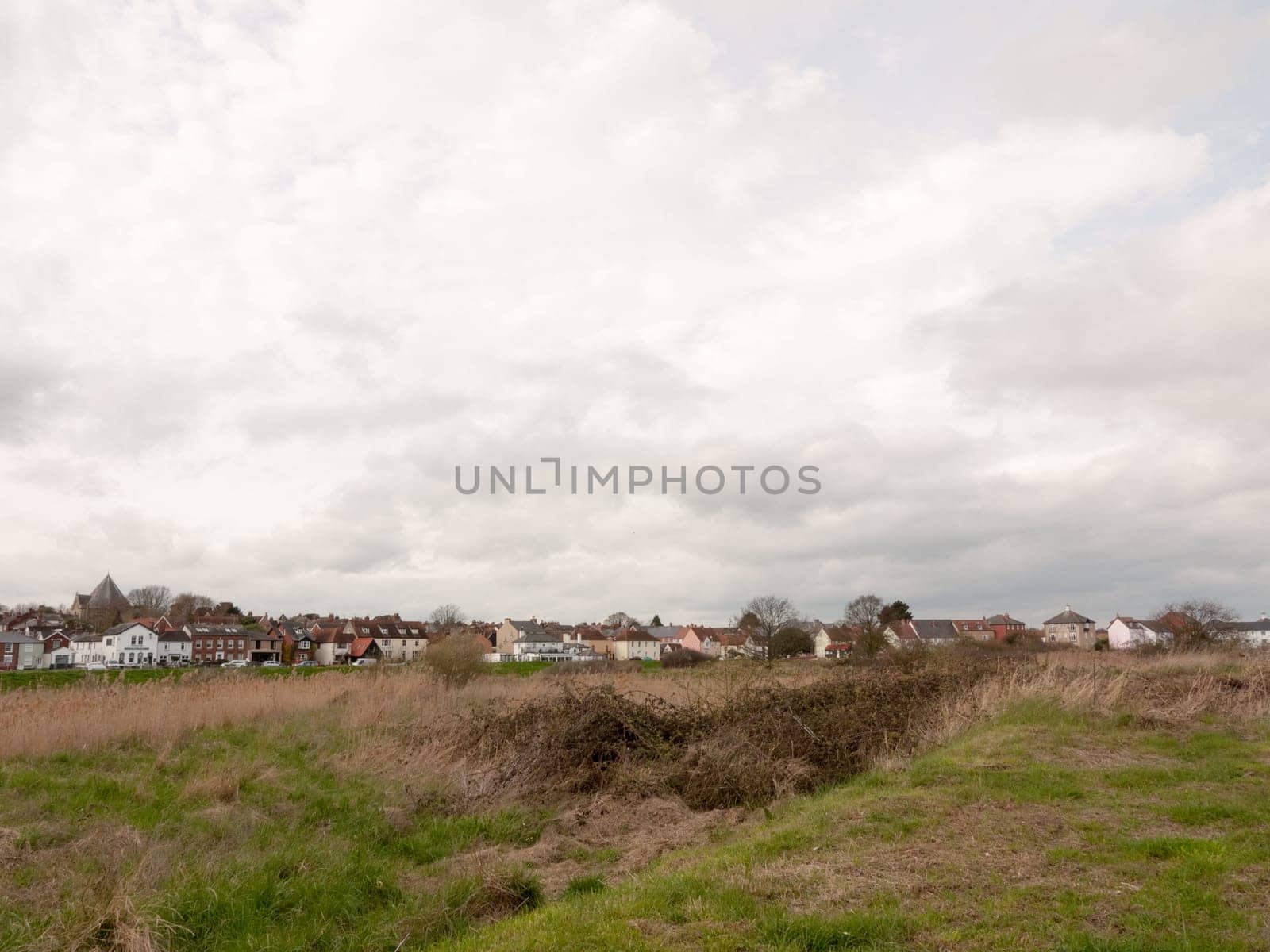 A field with houses in the far distance