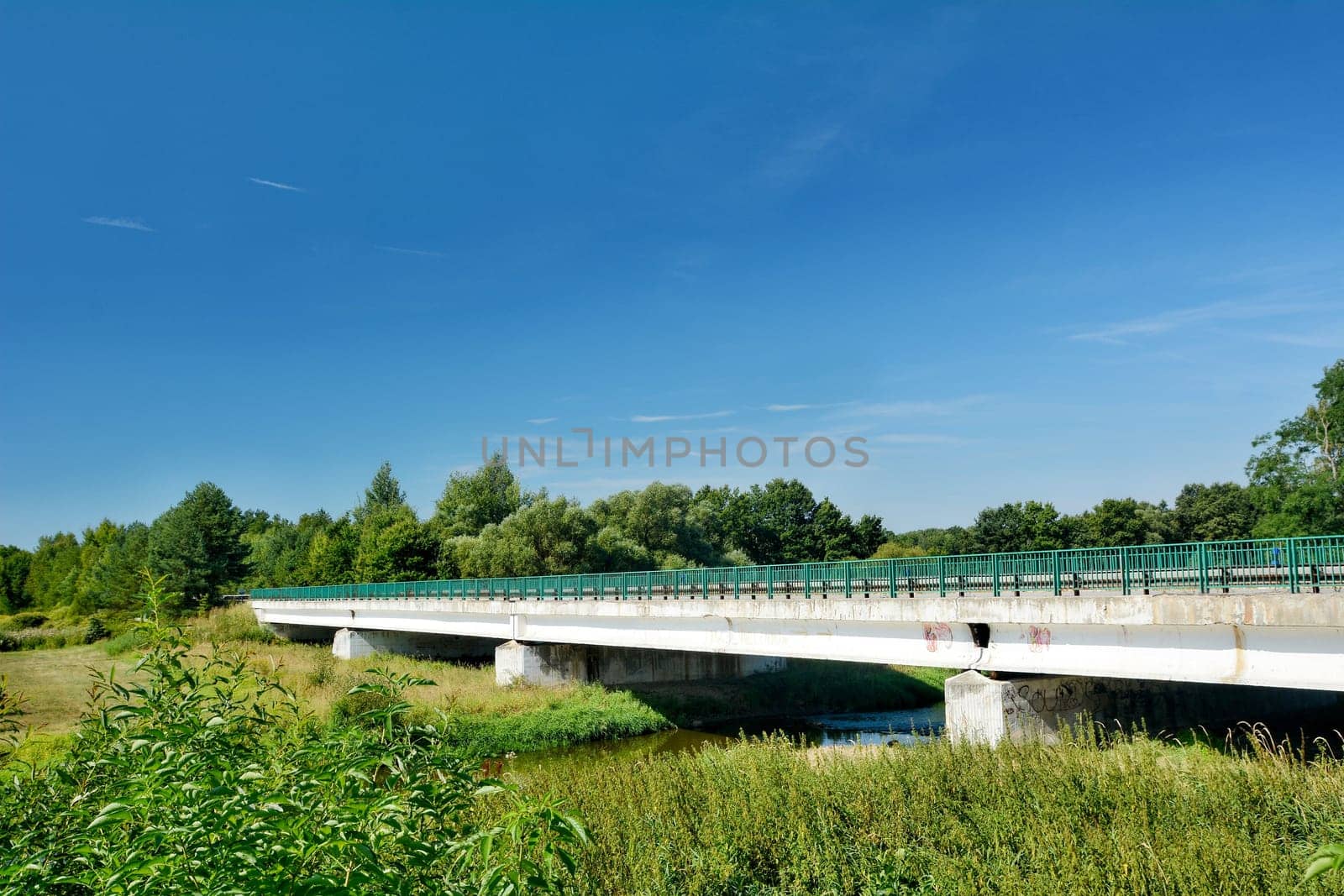 Old concrete road bridge over the river.