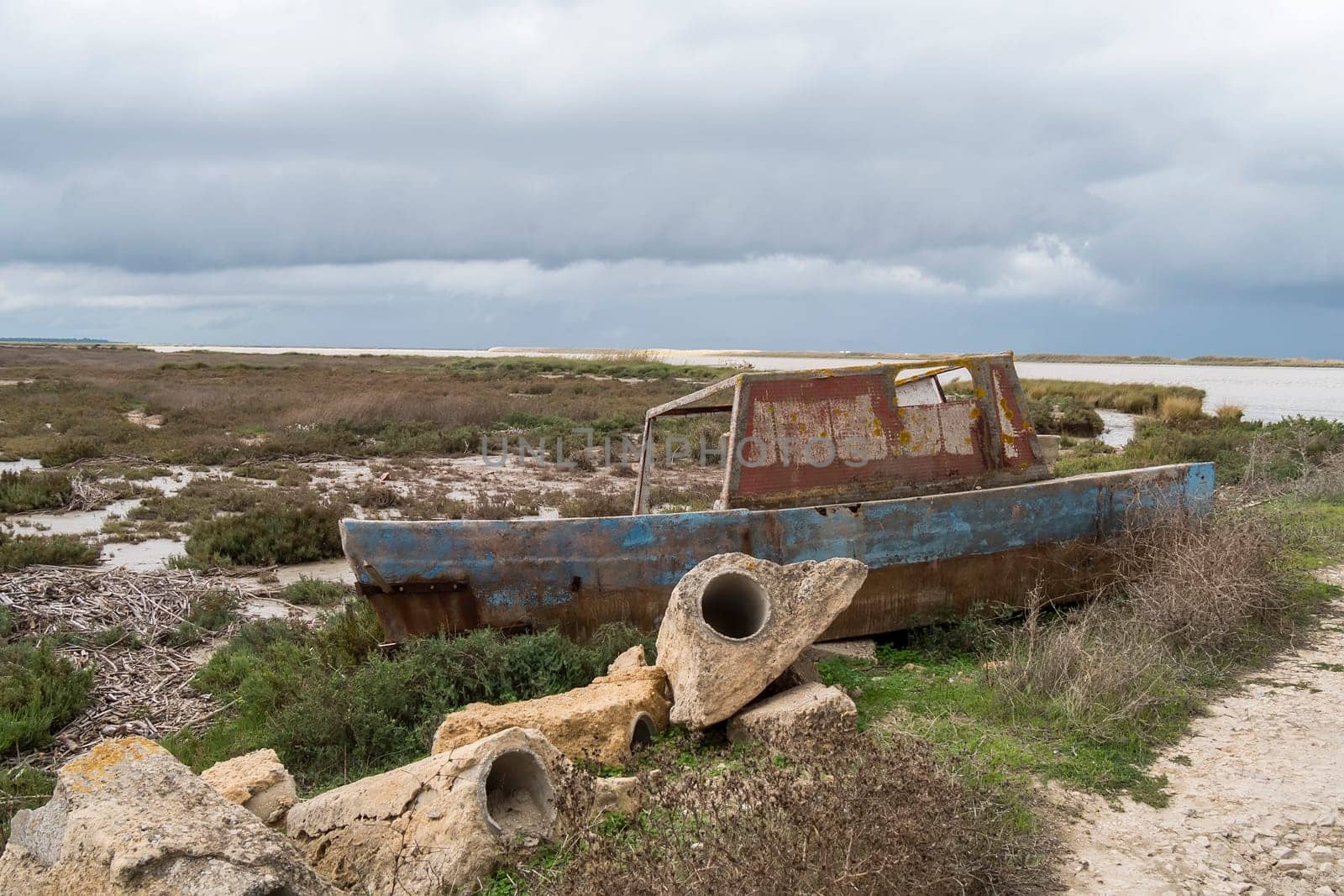 Old fishing boat abandoned on the riverbank