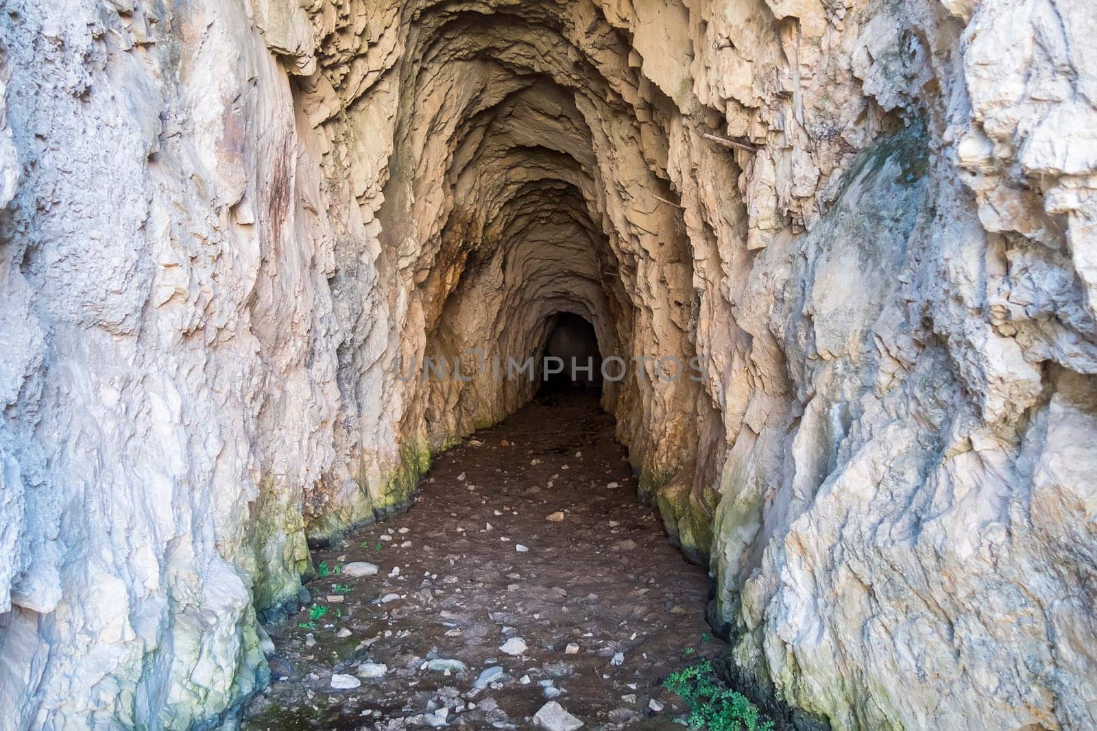 Deep, dark cave in the mountains.