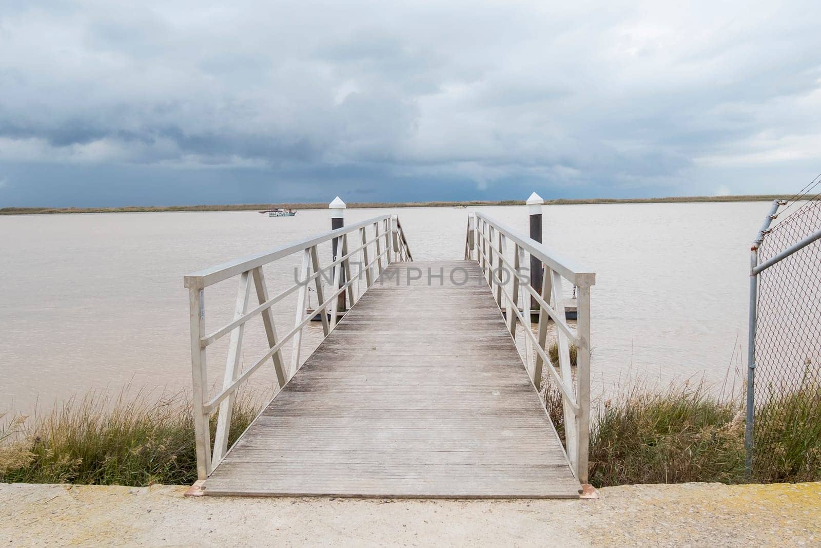 Wooden pier river on a cloudy day
