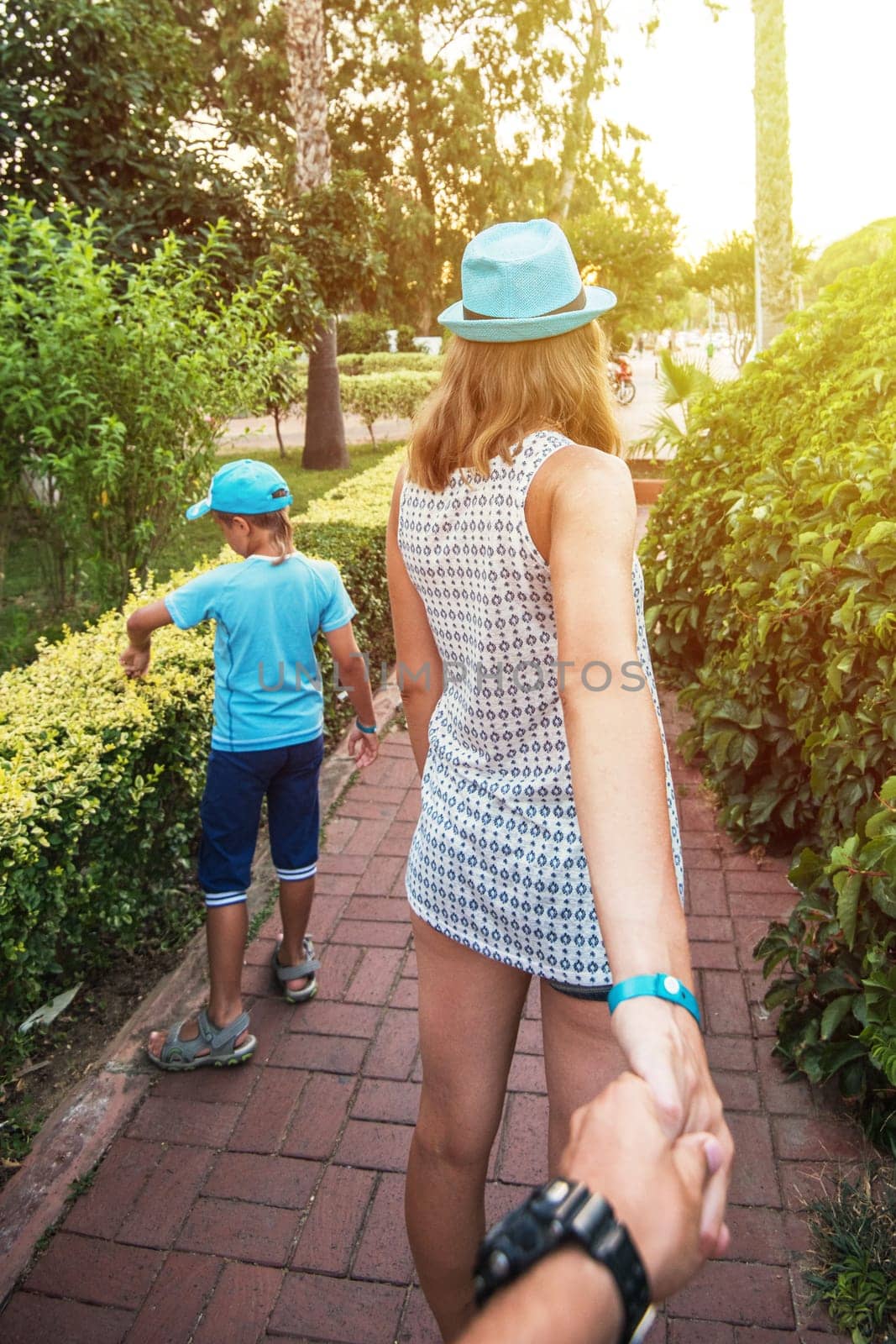 Family with man, his wife and son walking around the Alanya city in Turkey