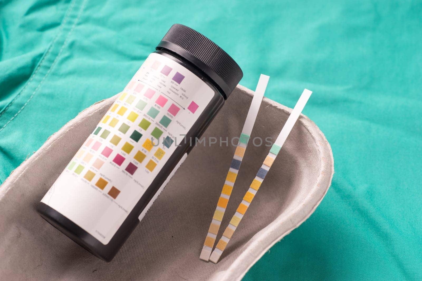 Medical Stethoscope lying on the hospital's green background. The background can be a textile part of a doctor or nurse's work uniform