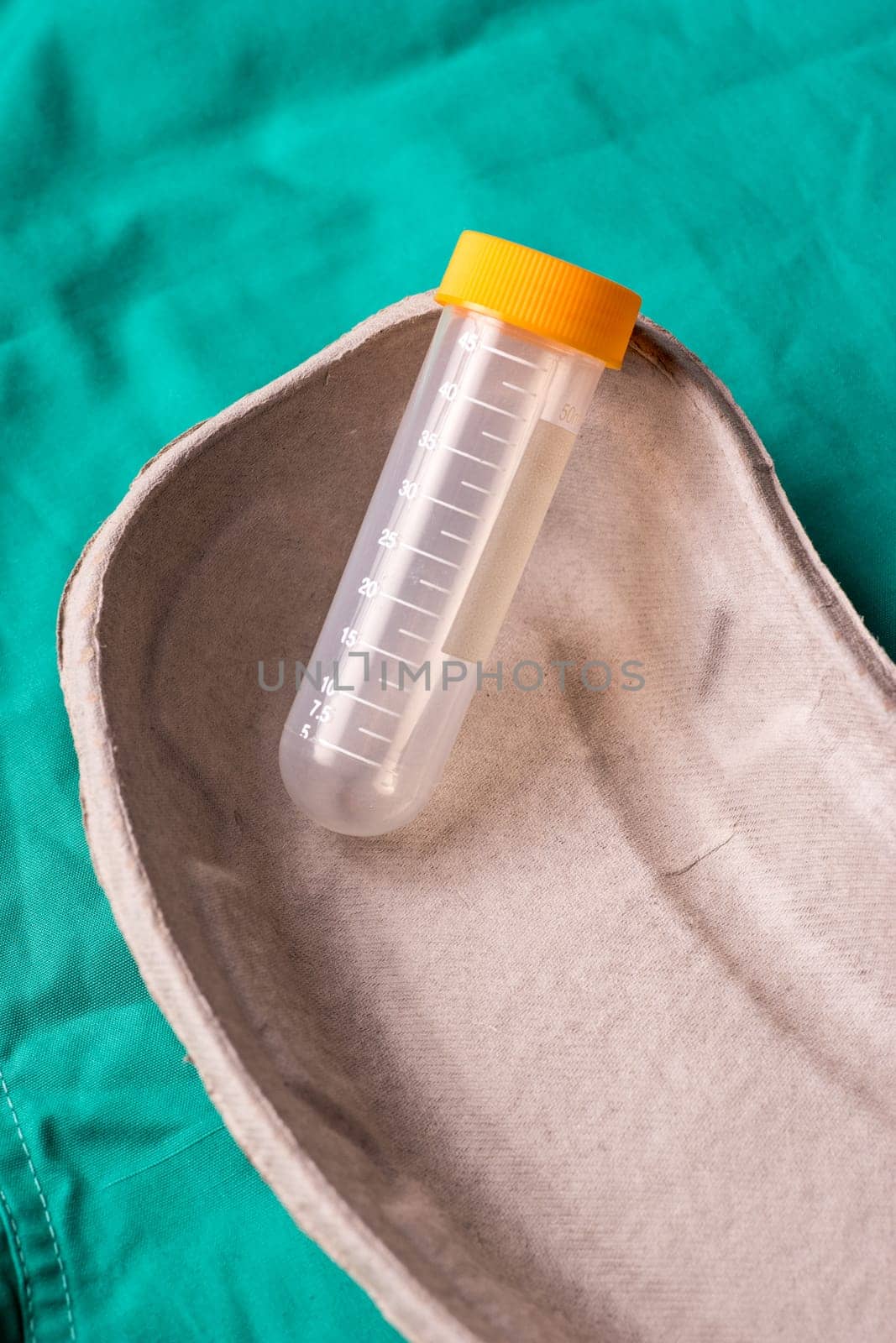 Medical Stethoscope lying on the hospital's green background. The background can be a textile part of a doctor or nurse's work uniform