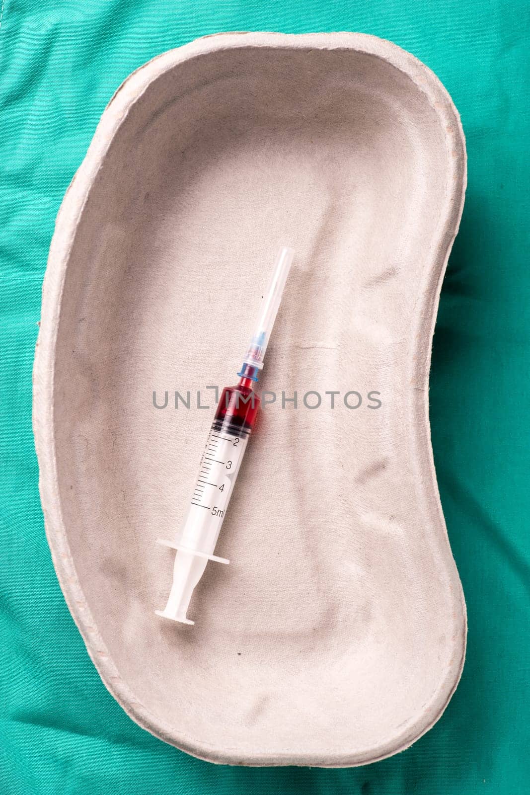Medical Stethoscope lying on the hospital's green background. The background can be a textile part of a doctor or nurse's work uniform