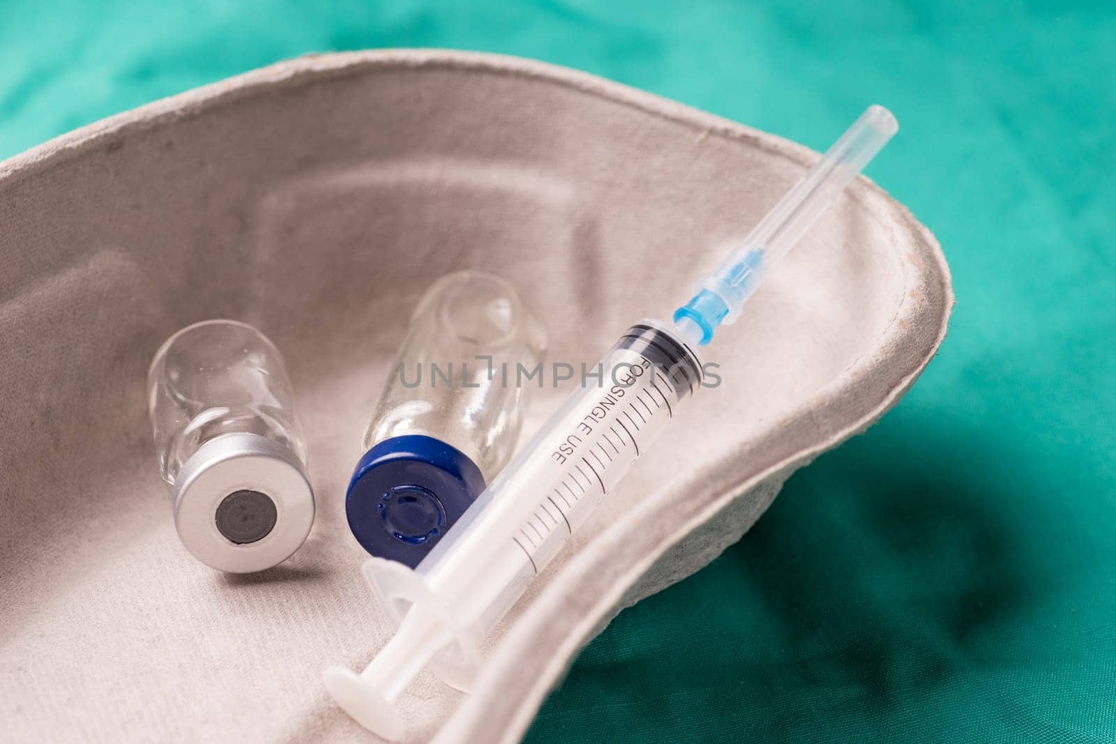 Medical Stethoscope lying on the hospital's green background. The background can be a textile part of a doctor or nurse's work uniform